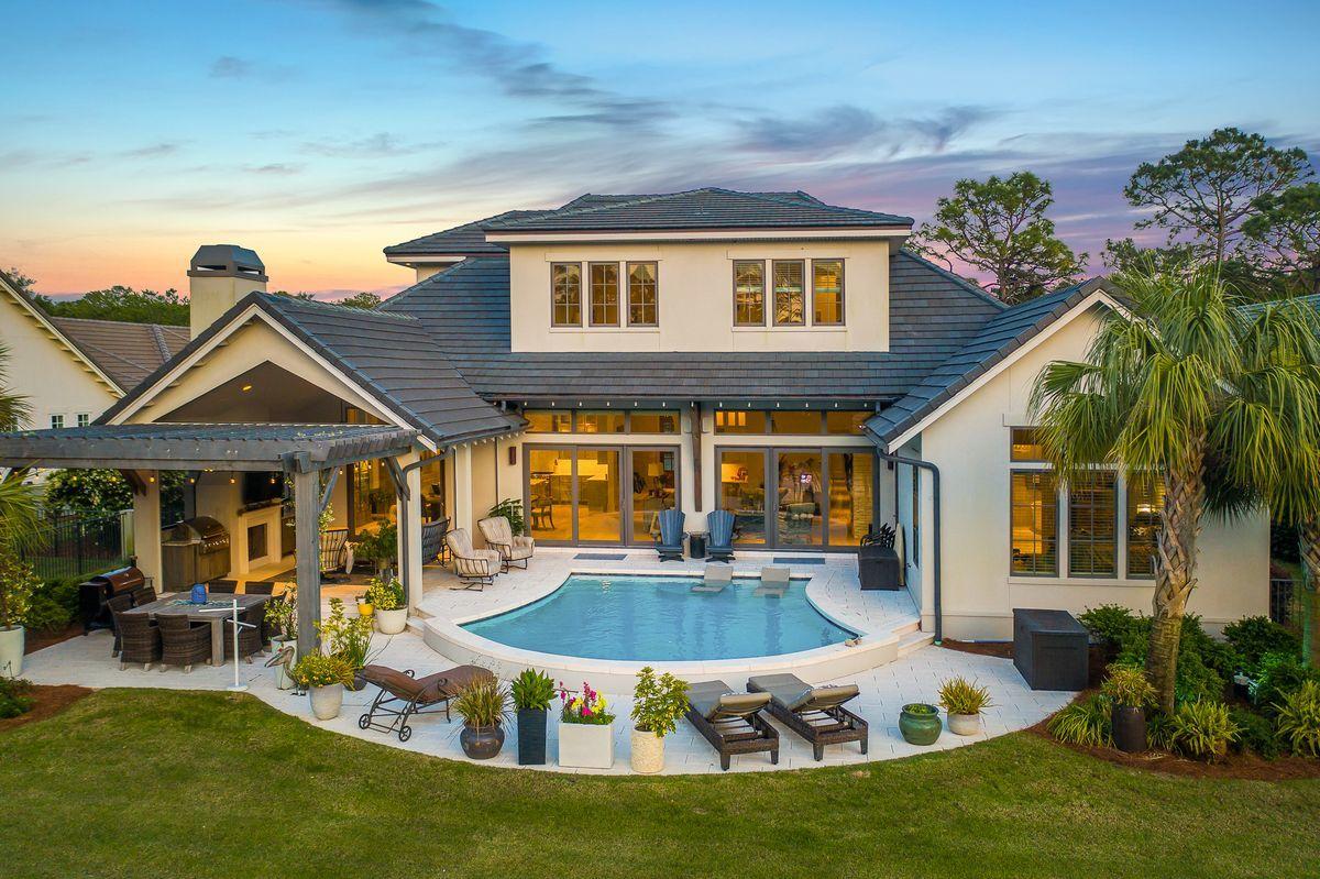 Modern elegance meets artful coastal contemporary design in this extraordinary lakefront residence ideally located in the prestigious gated community of Regatta Bay. Completed in 2018, this finely appointed home offers striking architectural detail juxtaposed coastal interior design masterfully configured featuring four spacious bedroom suites, four and one half bathrooms as well as a spacious open floor plan characterized by expansive single-floor living & gorgeous designer appointments throughout. Notable features include 12' ceilings on the main level, oversized three car garage with ample parking, hardwood flooring throughout, a spacious living room anchored by a contemporary gas stone fireplace and allowing easy access to the oversized outdoor lanai complete with phantom screens for optimal outdoor living as well as a secondary gas fireplace, in-ground pool with gorgeous paver surround, surround sound and perfectly situated to capture northwestern facing sunsets including views over the lake. The designer kitchen is well appointed and beautifully finished, complete with custom cabinetry topped with timeless marble countertops and accentuated by stainless steel appliances including a built-in Wolf coffee maker, 60" Wolf gas range and built-in Sub-Zero refrigerator. The kitchen freely flows into the open dining room which includes a handmade dining room table from Napa Valley and also offers a butler's pantry with a secondary oven and exceptional storage space. The master suite exudes coastal charm with 14' vaulted ceilings and a spa-like master bathroom complete with a soaking tub, dual vanities, marble flooring and oversized walk-in shower with suspended glass surround. The 13x14 master closet is an exemplary space of its own, with direct access from the master suite it features custom-built shelving for optimal storage. The mud room / laundry area also connects to the master closet for optimal ease of use. The first level also features a full secondary bedroom suite with adjoining bathroom as well as a separate home office adjacent to the entryway which offers pecky cypress ceilings and a curated stairwell leading to the second floor. The second floor offers two additional bedroom suites complete with ensuite bathrooms as well as a fifth living room space that offers a small kitchenette and ample storage. Other notable features include a commercial lift system in the garage for ease of use in maximizing attic storage, impact resistant windows and doors, Control4 home automation including window treatments, private wine cellar and an estate style entry with ample parking in the private parking court.

Regatta Bay is an exclusive gated enclave set in the heart of East Destin highlighted by it's par-72 golf course & meticulously manicured grounds & clubhouse. The community is strategically located within close proximity to boutique shops and restaurants in the Destin Commons as well as Whole Foods market and premium outlet centers all catering to the executive lifestyle this location affords.