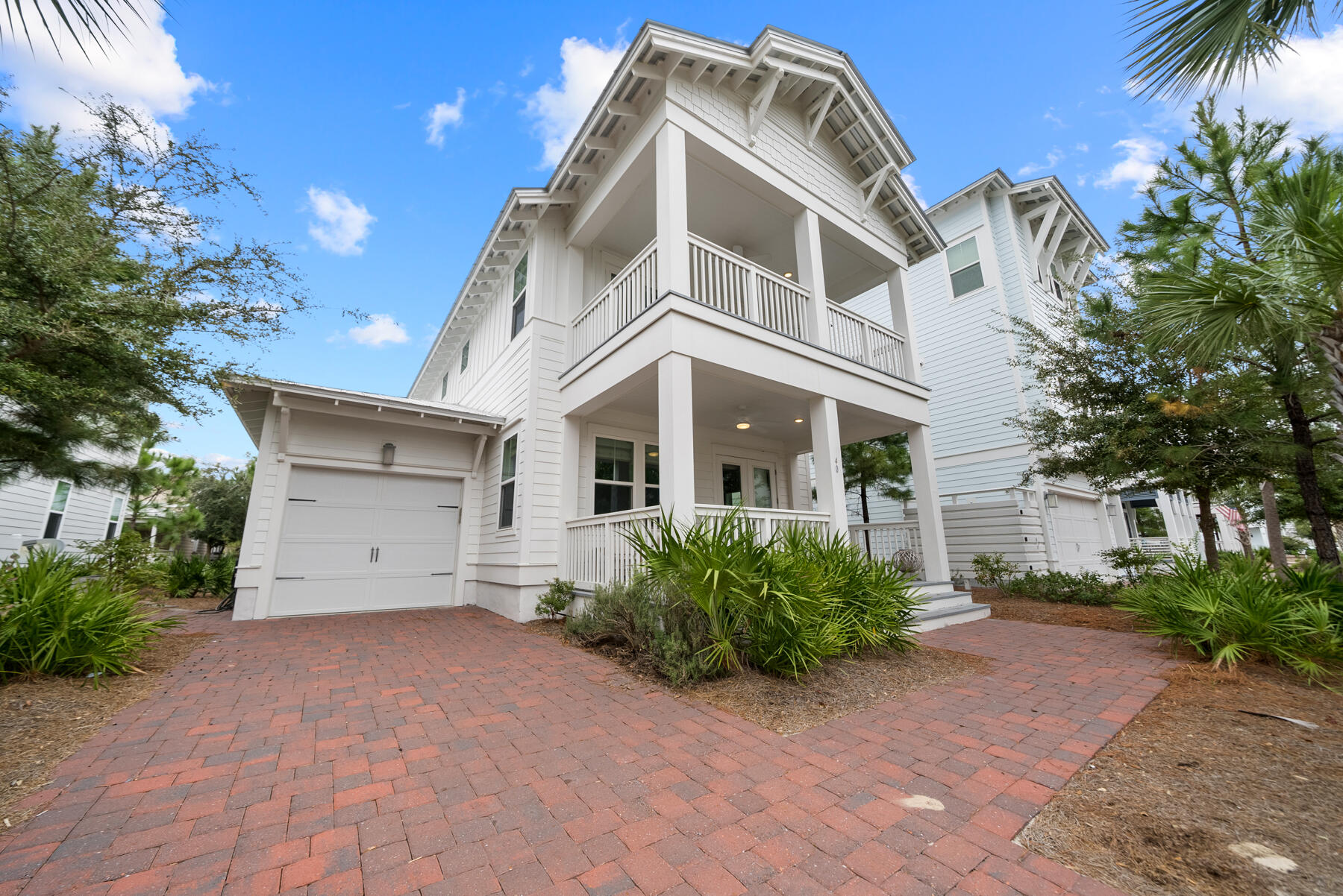 Escape to 30A in this modern coastal home in the heart of Prominence. This is a prime location situated between Watersound and Seagrove, with two beach accesses a short stroll away and just steps away from The Big Chill which offers multiple dining options, boutique shopping and entertainment daily! 40 W Crabbing Hole Lane is the perfect investment property or vacation home offering modern luxury living, an ideal location and memories waiting to be made.

Step into this light, bright coastal charmer that features an open floor plan, 4 bedrooms, 3.5 bathrooms and a 3 covered porches you'll use year-round in Florida. This home is offered fully-furnished, turn key with a golf-cart included and ready to rent! From the moment you arrive, you'll be fascinated with the design of the beach community of Prominence. Full of charm, amenities and with short term rentals allowed, in the town of Prominence you're greeted by families riding bicycles, neighbors walking their dogs, and friends walking back from The Big Chill with margaritas! Upon approach, you'll notice this home faces southwest allowing you to enjoy the beautiful sunsets nightly from the comfort of your own on home on two spacious covered porches. Walk in the front door and you're greeted by wide open spaces with custom woven window coverings, hardwood floors and coastal shiplap clad walls. The kitchen is stunning with quartz countertops, upgraded stainless appliances, large peninsula with seating and a walk-in pantry. The oversized windows also allow natural light to flood in year-round blending perfectly with the modern, bright interior design.

Behind the kitchen, you'll find a convenient powder room for guests, the laundry room, access to the large screened-in porch and a highly-desirable main level primary suite. The primary suite features lovely natural light, modern furnishings, a tiled walk-in shower, double vanities and a walk-in closet. The screened-in porch is where you'll be watching football during the fall and movies during those summer nights at the beach. Spacious enough for dining and relaxing, this outdoor living space is an entertaining dream overlooking the common green area of the neighborhood allowing for beautiful landscaped views. 

Offering a well-thought design and floor plan, the upper level features a nice loft area at the top of the stairs giving access to the three additional bedrooms and a guest bathroom. One of the three guest bedrooms is a junior suite with a private en suite bathroom and a large walk-in closet making it a great home for multiple families. The two additional bedrooms give access to the covered porch on the front of the home making it a great place to enjoy coffee each morning when you wake up before everyone else! 

Step into paradise on 30A in Florida and own your own slice of paradise in Prominence. This community offers 2 community resort-style pools, a fitness center, pavered sidewalks throughout and lush landscaping. Surrounded by crashing waves on the sugar white sandy beaches and blending perfectly with southern coastal charm, the 30A area is one of the hottest vacation destinations in the south. This unique gem in Florida offers fine dining, the best hospitality, walkability and biking catering to an active lifestyle. 

Prominence is located adjacent to The Big Chill also known as the world's largest back yard and features dining, shopping and entertaining for the whole family. You're just minutes from famed Rosemary Beach and the town of Seaside. You're also just steps from world-class amenities at the Watersound Club and if you choose to join as a Member, you'll enjoy private beach access, multiple restaurants and bars, tennis, resort-style pools and more.

Get ready to live your best life on 30A!