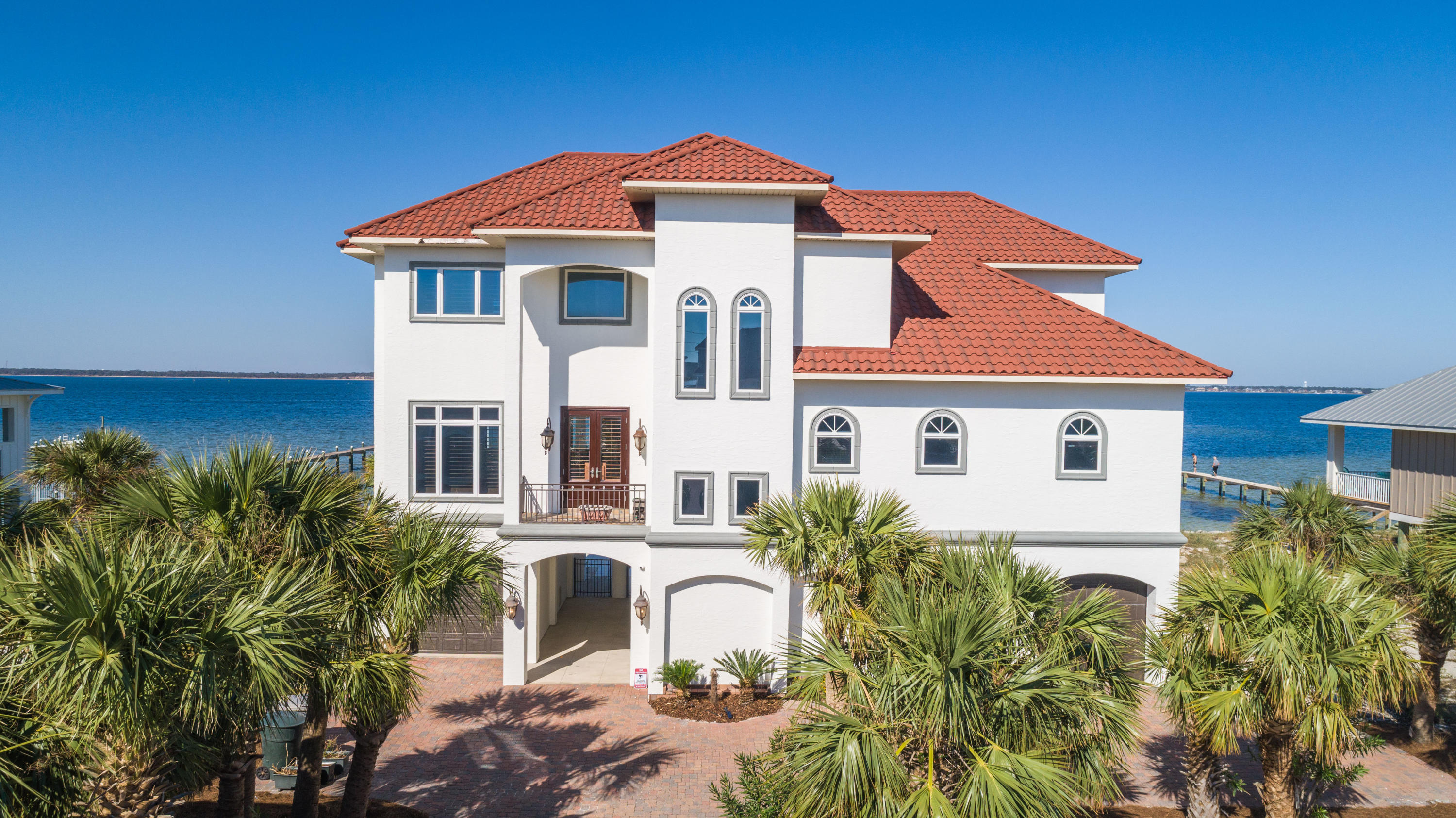 UNDER CONTRACT BUT TAKING BACKUP OFFERS. Situated on the Santa Rosa Sound with 105 feet of water frontage, this Mediterranean Estate was built to stand the test of time. With concrete pilings that go 38 feet down and ICF construction (Insulated Concrete Form), this fortress was well planned and has so many magnificent features. The chef's kitchen comes equipped with soft close custom cabinetry, Italian granite, 6 burner gas hood range, sub-zero fridge and wine fridge, LG wall oven and convection oven, ice maker, instant hot and cold water, and walk-in pantry. The impressive media room has a 1080P Anamorphic resolution projector with a 12 foot Microperforation screen, leather hydraulic recliners with seating for 8 pe ople, fridge, dishwasher, sink, popcorn maker and microwave all for your convenience. A list of stand-out features are, elevator to the 3rd floor, 300 foot THRU FLOW dock that will support 50 foot yacht, 2 jet ski lifts, backyard plumbed for pool, irrigated landscaping, solar landscape lighting, climate controlled garage spaces for 5 vehicles, Geothermal heat pump, spray foam insulation, all mechanics inside to prevent corrosion, Whirlpool reverse osmosis water filtration system, security system, top rated "E" Anderson windows, security magnetic safety lock on ground floor, 500 gallon propane tank, Sonos surround sound throughout the home and exterior, outdoor kitchen with African Teak and plumbed for gas grill, plantation shutters, Sound views from every bedroom, motion lighting in closets, half bath and garage, motion exhaust fans, custom drapes, solid wood doors, programmable fireplace, kitchenette in master suite, 2 way mirror and hidden TV in master bath, glass railing to not obstruct views and staircase railings hand made by local artist. The quality of this home is unparalleled. Check out our full video tour on the MLS and YouTube.