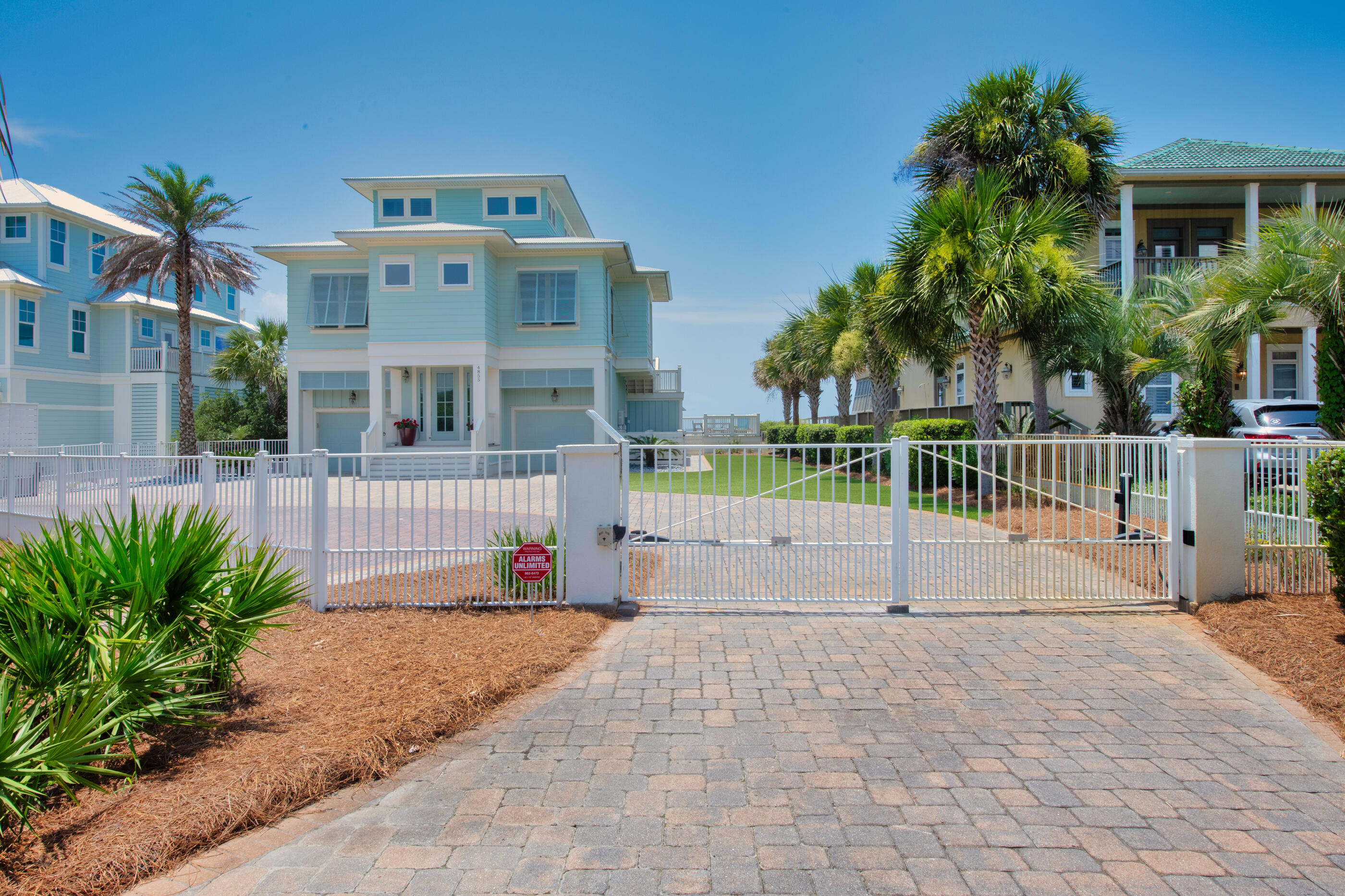 Enjoy gorgeous panoramic views of sunrise and sunsets over looking the white sandy beaches on the Gulf of Mexico from your gated, gulf front estate. First floor has 2 large bedrooms with ensuite.  Walk out of either bedroom & enjoy your gulf side swimming pool, covered patio, large swing & private beach walkover. From the 1st floor you can access the 2 separate garages and there is additional storage under the stairs. Going to the 2nd floor, you are greeted with a large open floor plan with kitchen, dining area & living room overlooking the gulf. Two additional guest bdrms with ensuite , a guest bathroom with shower, separate laundry room with sink & ice machine with plenty of storage.  The master suite is on the 3rd floor with open deck to absorb the sun & watch the dolphins play. The master bath has a walk-in shower, soaking tub, double vanities with granite countertops. As you enter into the master suite, there is a wet bar with under cabinet and mini fridge.  A space for a computer room or office is also on the 3rd floor.  The kitchen features high end appliances with a 48" 6 burner gas cooktop, granite countertops, an island for additional seating and plenty of cabinet space.  All floors with exception to the bathrooms and laundry room are wired brushed solid wood. Home features a whole house Generac generator (replaced in 2021) new 400 amp service in 2023, all 3 HVAC systems were replaced in 2020 (comes with Peadon's warranty)  rinnai was replaced in 2022, pool pump was replaced in 2019 and heater in 2021.  The beautiful green area is Forever-lawn & never needs moving. Home is fully furnished with exception to the wifi and router system.  Buyer(s) are responsible to personally verify all details for property and dimensions. Any information contained in this listing is believed to be accurate but is not guaranteed.