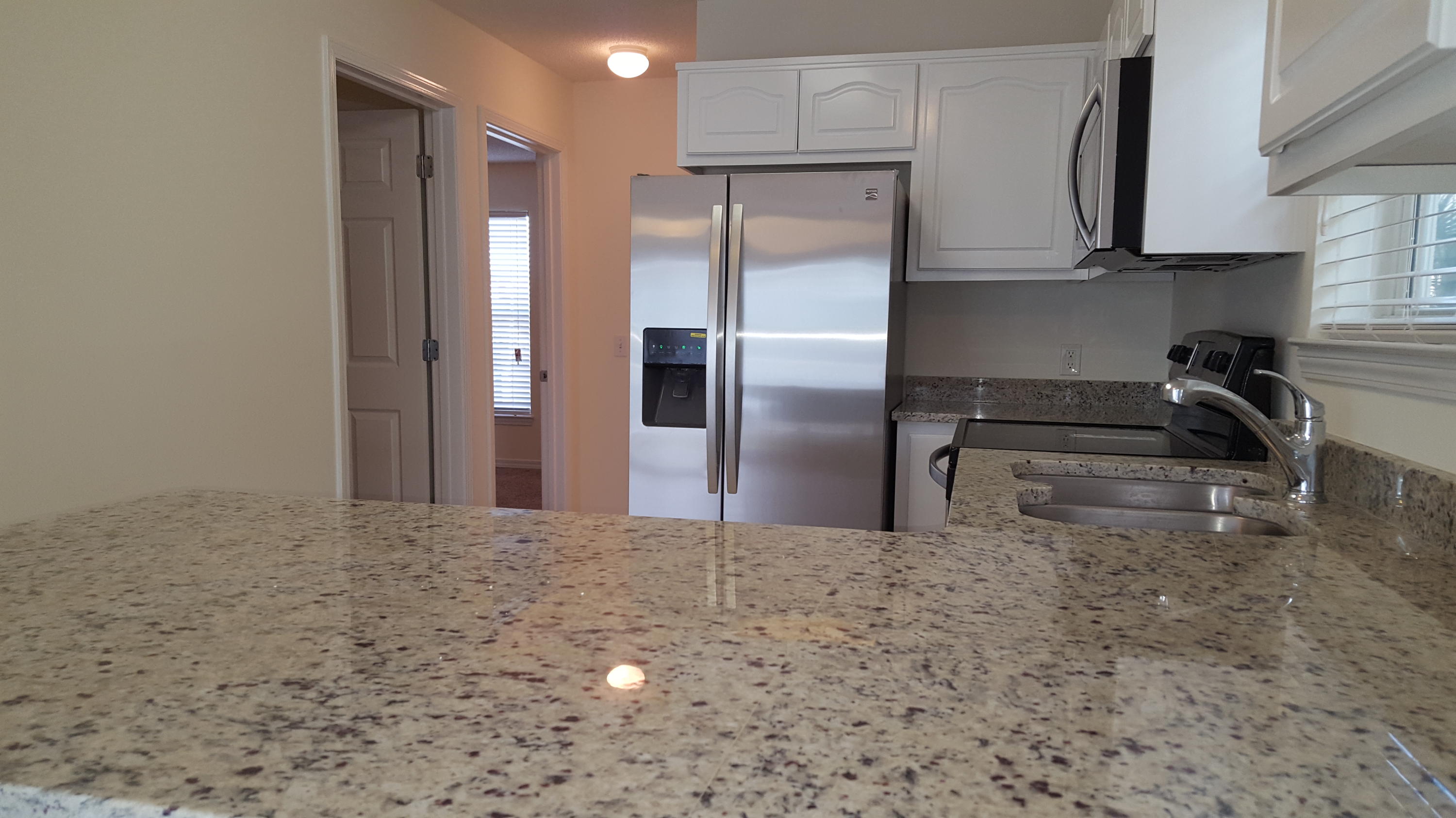 DEVELOPER UNIT !!Like new, completely renovated including granite kitchen counter tops w/under-mount stainless steel sink, all new stainless steel appliances, new faux wood window blinds, new sliding glass door blind, new paint thru-out. Beach access is directly south of community. Nice community pool with showers and restrooms. Association provides basic cable,trash and grilling area....GREAT NEWS; We are now VA approved !!