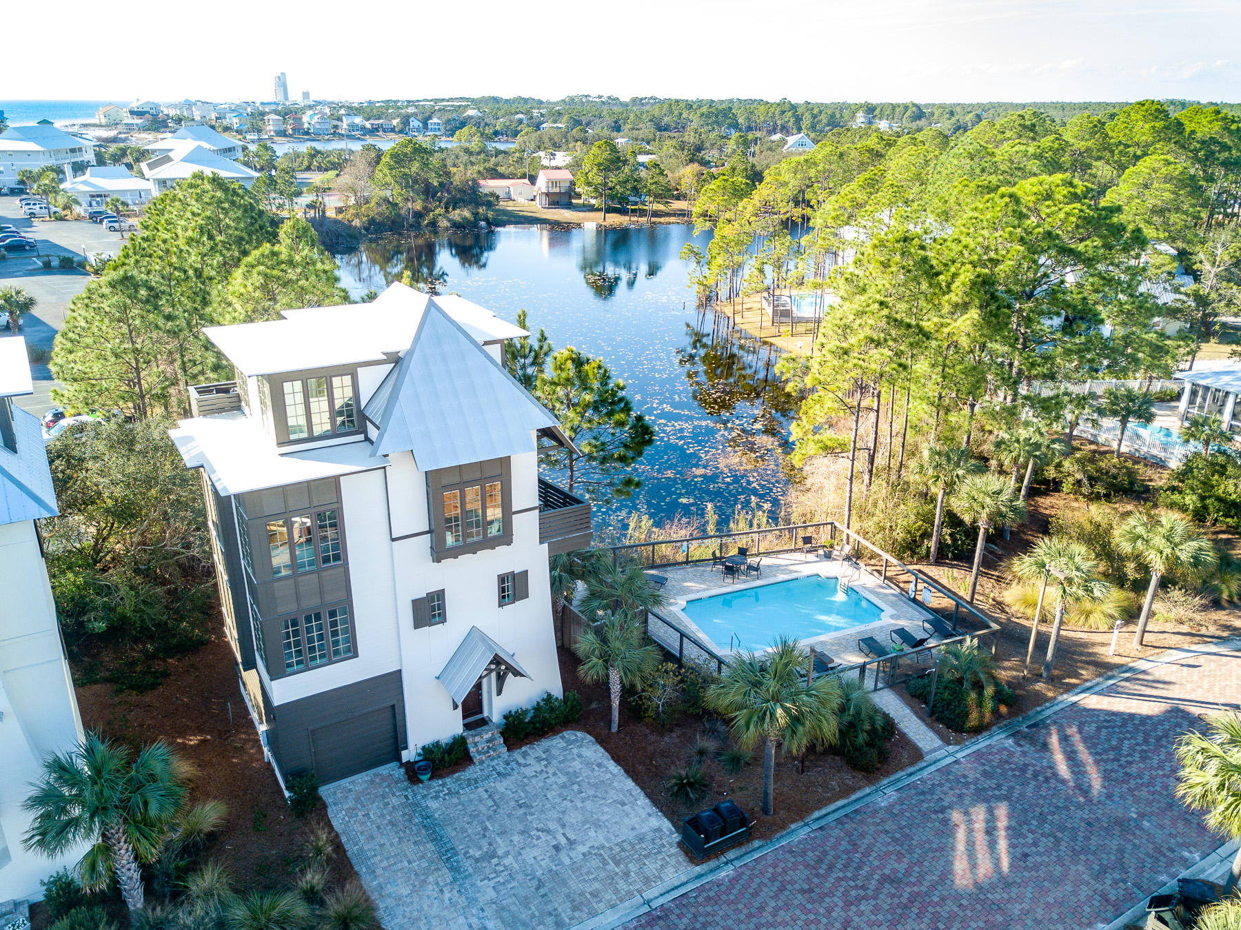 Located south of 30A in the quaint 9 home neighborhood of Tresca Place, 40 Seapointe Ln was built on a prime lot overlooking the adjacent coastal dune lake and community pool! Recently updated the home features upgrades throughout such as built-in first floor bunk room, elevator, custom cabinetry and tile, stainless appliances, and granite countertops.
The ground floor holds a spacious enclosed garage great for parking and storage, the built-in bunk room, and a half bath. The second floor houses the two guest bedrooms, and guest bath. The open concept main living area is found on the 3rd floor. Notable features of this area include the oversized windows providing beautiful natural light, and the large island and gorgeous built-in window seating that allow for maximum use of the space The luxurious master suite with ensuite bath and private balcony are all located on the top floor. Beautiful views and quiet enjoyment of a luxury coastal home await you here. You're just a short walk or golf cart ride from the gorgeous Seagrove beaches, and a few minutes from all of the shopping and dining of Scenic Hwy 30A. 

Buyer is responsible for verifying details about this property. All information is deemed to be accurate but not guaranteed.