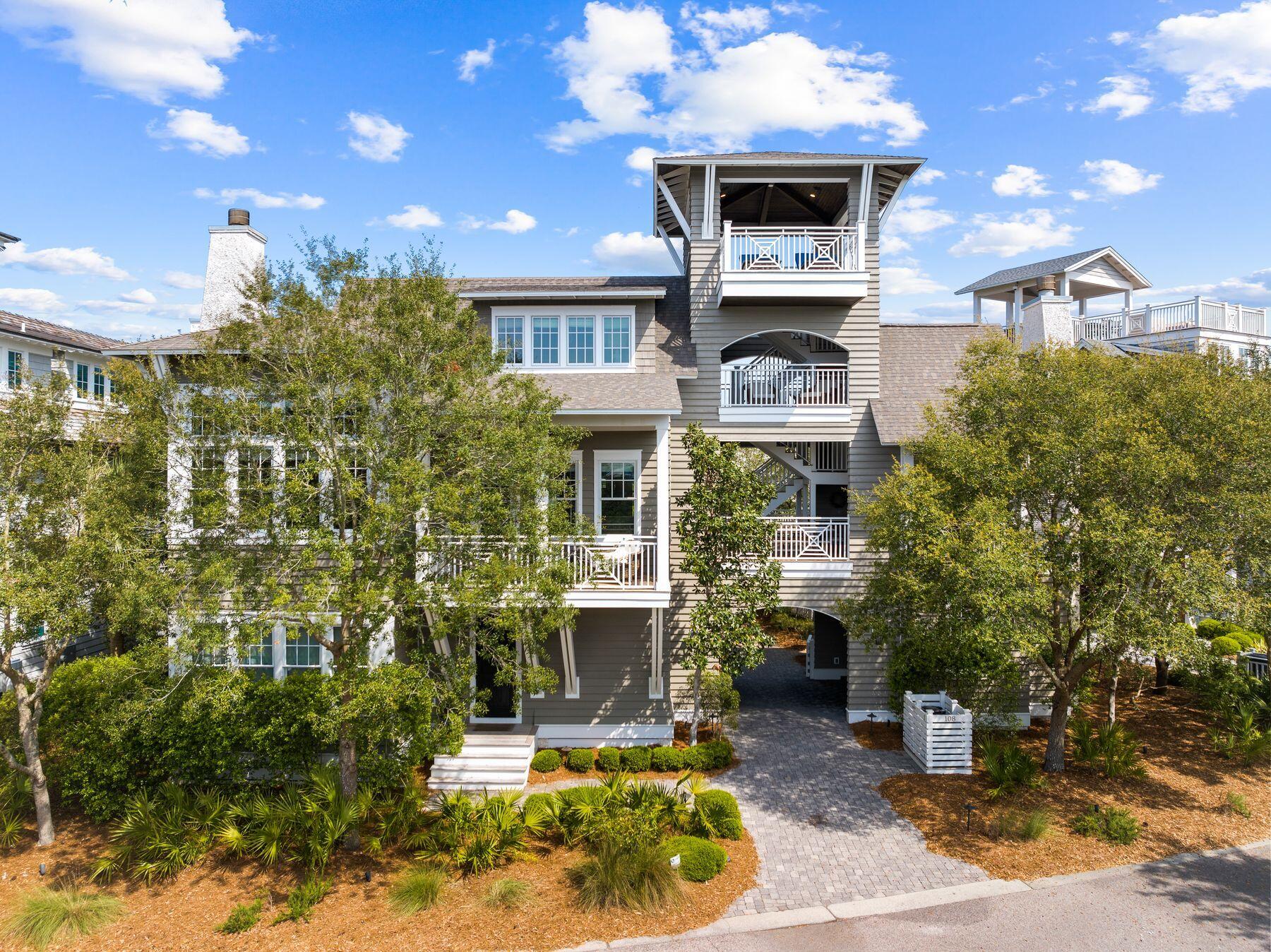 Occupying one of the largest lots in WaterSound Beach, this outstanding craftsman home boasts exceptional design features. Enter the courtyard through a covered entrance and pass the fountain, fire pit and detached office as you enter this magnificent retreat. Designed by Thurber Architecture and built by Rice Construction, a fourth-story tower with panoramic views of Camp Creek Lake and the Gulf of Mexico creates a breathtaking pinnacle. Multiple porches on all levels provide a plethora of outdoor spaces to enjoy stunning skies at sunrise and sunset. Second floor main living and dining areas boast soaring ceilings and pecky cypress accent walls highlighting the finer points of this luxuriously appointed home. Available fully furnished, the residence includes everything from hand-picked artwork to housewares and fine linens. Perfectly stained five-inch oak floors convey a sense of luxury and permanence in the living room while hand-crafted chandeliers and delicate silk draperies introduce a graceful touch. The latest technology is embraced with remote-controlled shades and a wireless Sonos Sound System throughout the house, controlled from your iPad or iPhone. The gourmet kitchen has Carrara marble countertops and a dumbwaiter (lift). Top-of-the-line appliances include a Sub-Zero refrigerator, new ice maker and a dedicated wine fridge, ensuring drinks are perfectly stored and chilled before serving. The first floor has three spacious suites including a master retreat with a lavish marble bathroom with a jetted tub and exquisite tile. Another master on the second floor outshines the rest with an ensuite bathroom and walk-in closets, including a personal washer/dryer. It adjoins an enclosed private library/study with fireplace nestled among the trees. The third-floor loft offers an additional guest suite with views of the peninsula and rare dune lake from the adjoining deck. Pet owners will love the secure fenced yard and the gate leading out to the neighborhood dog park. Enjoy the amenities of Watersound Beach including private beach access, docks along Camp Creek for kayaking and paddleboarding or make use of the community fitness center, three miles of boardwalks for walking and jogging and community pools.