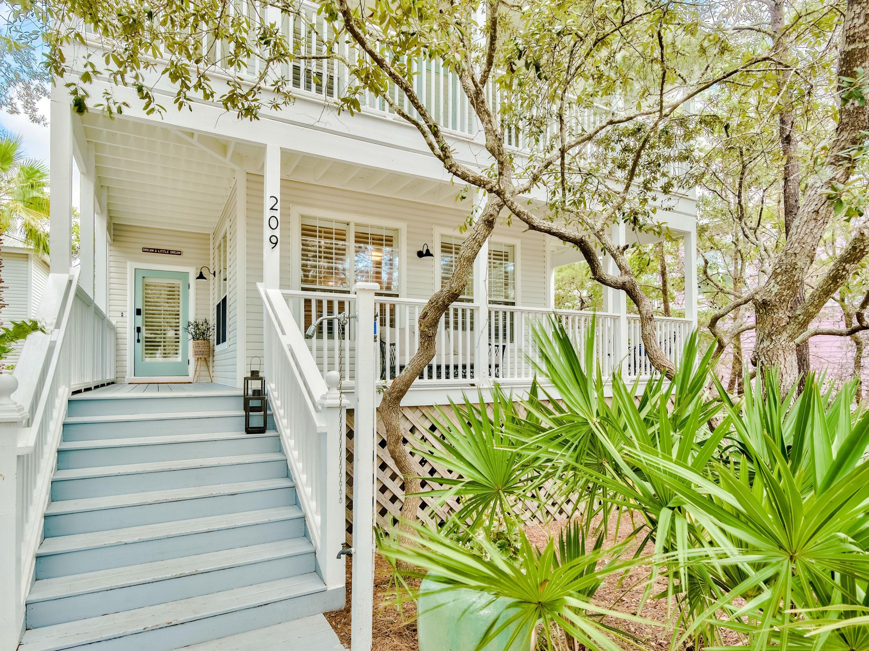 Located on a generous 1/3-acre lot backing up to Draper Lake, this spacious home with coach house has views of the lake and Gulf of Mexico. Enjoying a private location in a gated community, this three-story beach house has a bright open great room with tile flooring and wood-clad walls in muted gray. The soft natural tones continue through the home, creating a relaxed coastal vibe and reflecting the natural elements of the surroundings. The kitchen is a well-appointed space with a generous island breakfast bar, updated countertops, kitchen appliances and new faucets.  The second-floor master suite is an enviable space with its own private balcony. The spacious master bath is a haven for relaxing with a whirlpool tub and walk-in shower. A second huge bedroom on this level currently has two sets of three bunk beds, a play area, sofa and TV. There's further versatile space on the third floor. Currently used as a fifth bedroom, it would make an excellent bunk room or family game room. Guests and independent family members have their own space in the separate one-bedroom coach house above the garage. Located in the coveted neighborhood of Old Florida Beach, this beautiful beach house is steps from the lakeside dock, community pool and beach access. Boating, fishing and paddleboarding are part of the outdoor lifestyle. Restaurants, shopping and entertainment are a short walk away at Gulf Place and there's a bike path for exploring further afield. This turnkey property includes a new roof and all-new furnishings making it perfect as an investment, primary or second home.