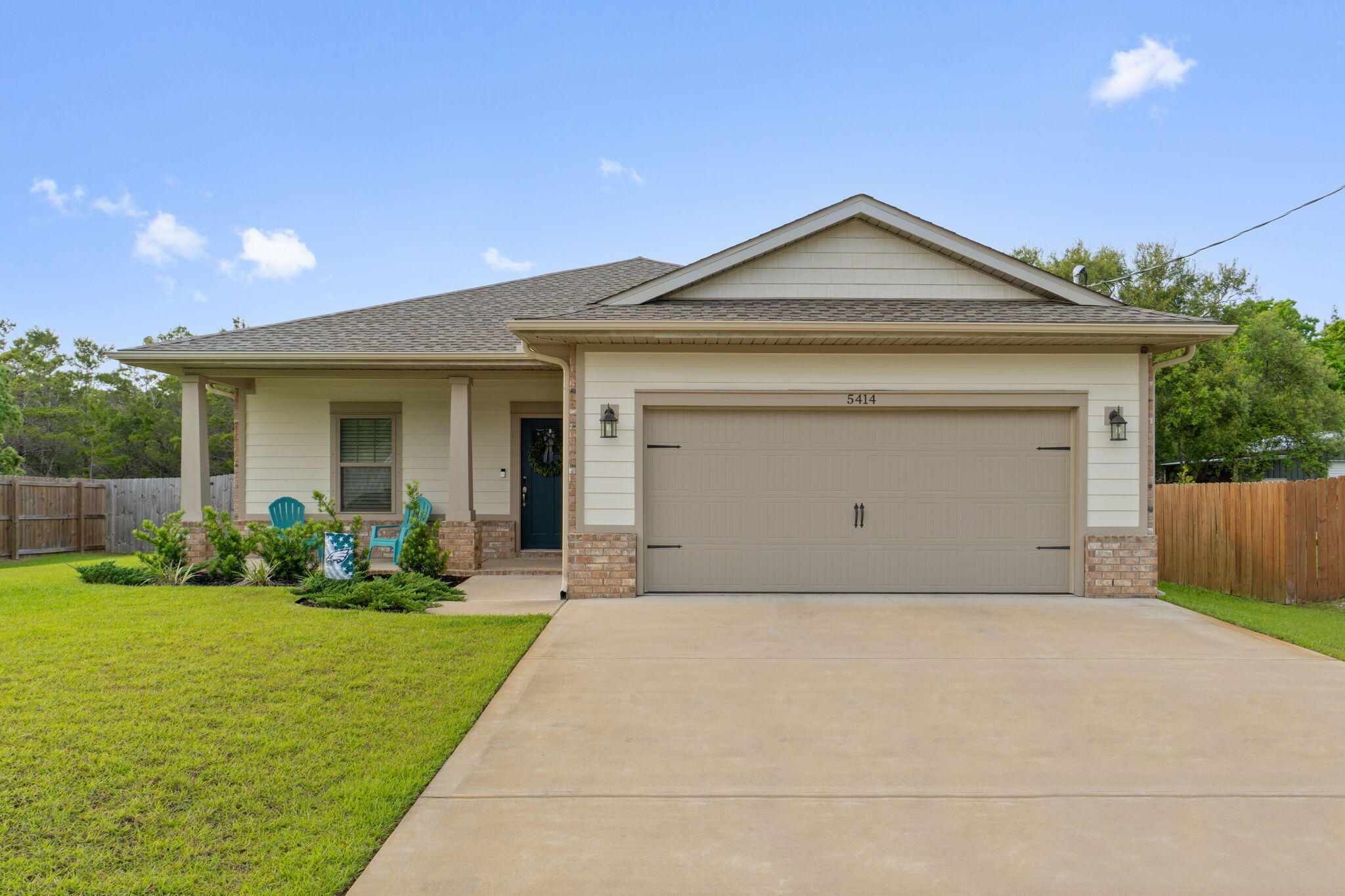 Welcome home to this exceptional and practically new move in ready 3 bedroom/2 bath home with many upgrades throughout on a great sized 0.27 acre lot with no HOA and walking distance to the Woodlawn Beach boat ramp! Adorned with the timeless durability of brick, cement fiber board accents, and an architectural shingled roof have peace of mind with a home and all major systems just installed in 2022. Pull into the driveway and appreciate the well maintained landscaping and craftsman style exterior with an adorable front porch. Enter inside and you'll immediately love upgrades like crown molding, trey ceilings, transom windows over the hall entryways for a custom touch, and bathrooms, and luxury vinyl plank flooring throughout all the common areas. This open floor plan with recessed  lighting features a great sized living room open to the well appointed kitchen where you'll find timeless white soft close cabinets and drawers, granite counters, stainless appliances, and drop down pendant lighting and is open to the dining room with another trey ceiling with crown molding. The master bedroom is a retreat in this split floor plan and has plenty of room for your king bedroom suite underneath another trey ceiling with an en suite that has double granite vanities, a walk in closet, framed mirrors and upgraded lighting, a soaking tub with tile surround, and a private water closet. The two additional bedrooms are found on the other size of the house with ample closet space of their own and another full bathroom with all the same updated finishes you're looking for. There is a great sized interior laundry room and the two car garage has an upgraded epoxy coating on the floor. Outside is a covered back patio overlooking the fully fenced in backyard complete with an irrigation system and gutters, and there is even a built in pest control system in the wall for easy treatment! Don't delay on this Gulf Breeze gem perfectly located near beautiful Emerald Coast beaches and experience the best of Florida living.