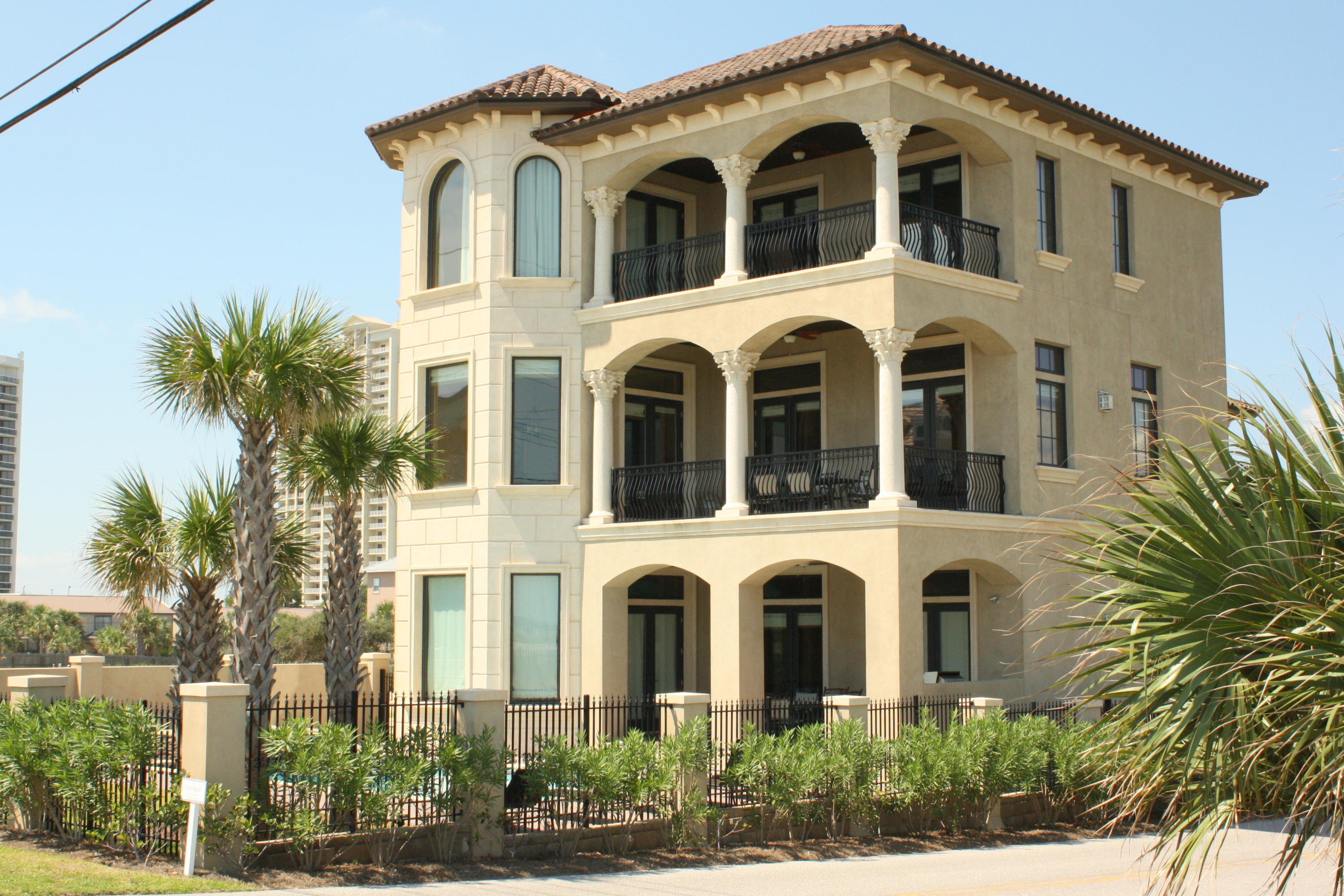 Fabulous Gulf view home, directly across the street from the beach with unobstructed views! ICF poured concrete construction with tons of upgrades and custom features including ruffled travertine floors, raised ceilings, trayed ceilings, crown molding, venetian plaster walls, stone showers, vessel sinks, granite counters, professional grade stainless appliances, elevator and more. First level has family room, complete with pool table, wet bar and fireplace, one bedroom, a bunk room, and access to the covered patio, summer kitchen and large, sparkling pool and spa. On the second level is an open leisure room/gourmet kitchen/dining area which opens to a large balcony, one master suite and a powder room. The third level has the grand master suite, two additional bedrooms and two baths. Finely appointed throughout, tastefully furnished and beautifully decorated. Very impressive rental income!