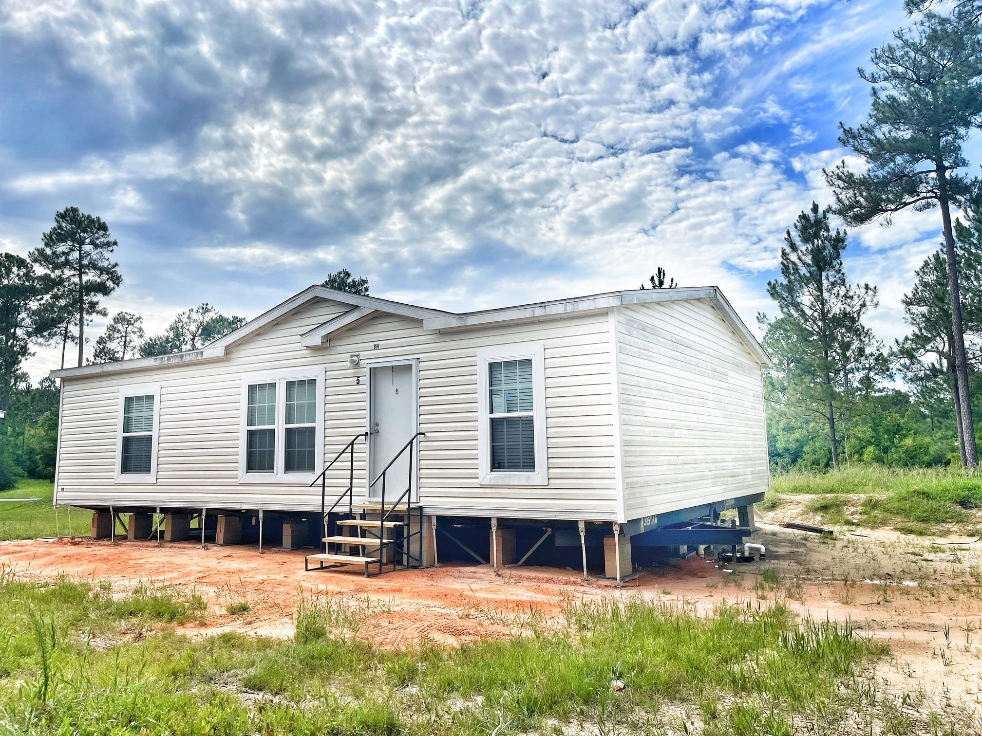 WATER FRONT!! This 3 bedroom 2 bath is like new! Open floor plan with built in entertainment shelving in the living area. Kitchen has tons of cabinets and counter space. Spacious master bedroom with large closet. This home will have skirting added this week. New septic and city water. All measurements must be verified by buyer.