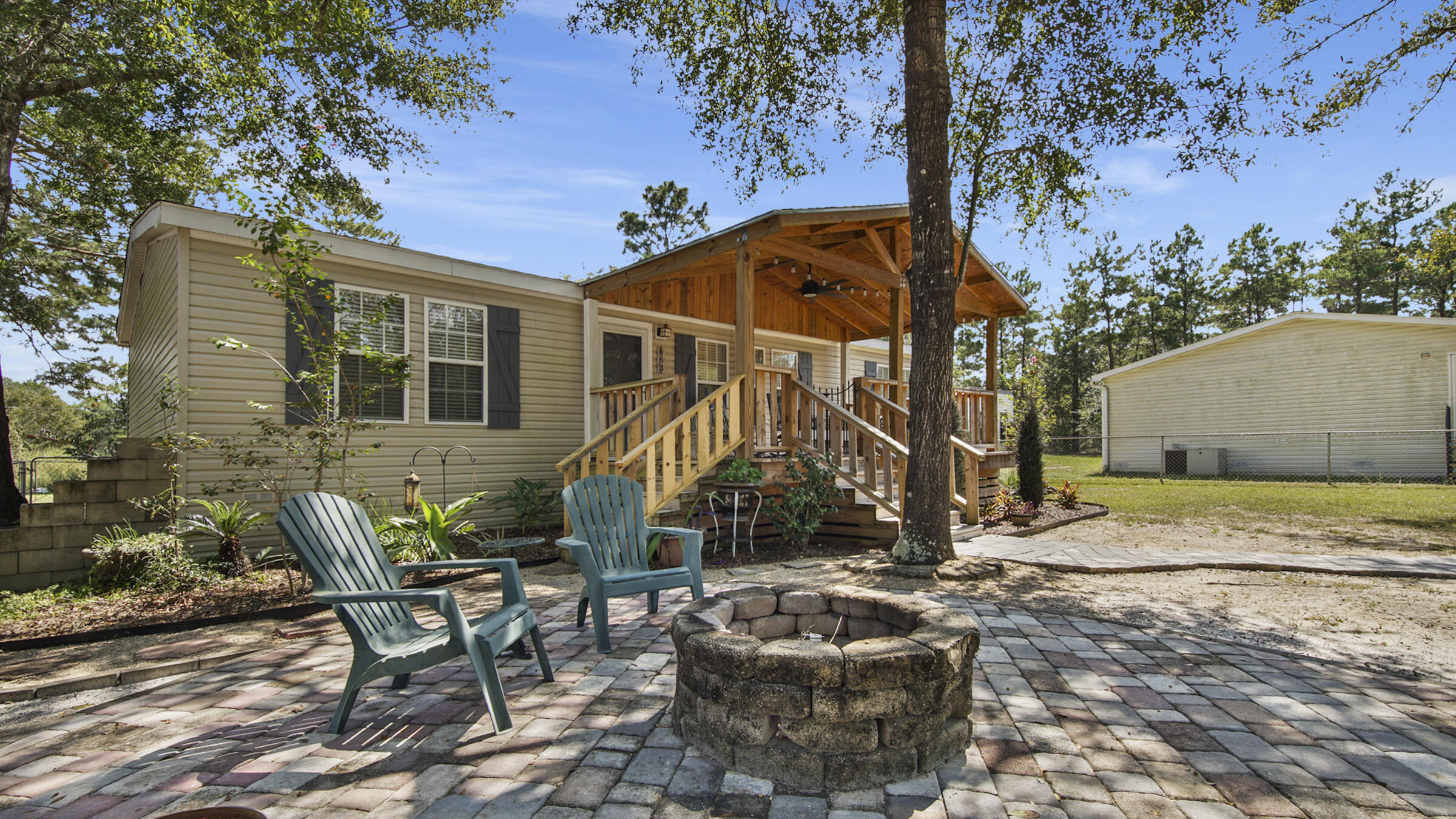 This home has been updated in most every possible way to showcase the most current trends as well as the utmost desires and needs! With a brand new roof, this is not your average manufactured home. Custom details are evident everywhere you turn. The kitchen is perfectly outfitted to beautifully meet the need of the cook of the home. The split floor plan helps keep privacy between the owners and guests or kids.   Well maintained and is ready for the new owner to make it home. You'll appreciate relaxing on the covered front porch and enjoy the fully fenced back yard on this 1/3 acre homesite for all the activities that await you. Even if that's just letting the dogs or kids out!
