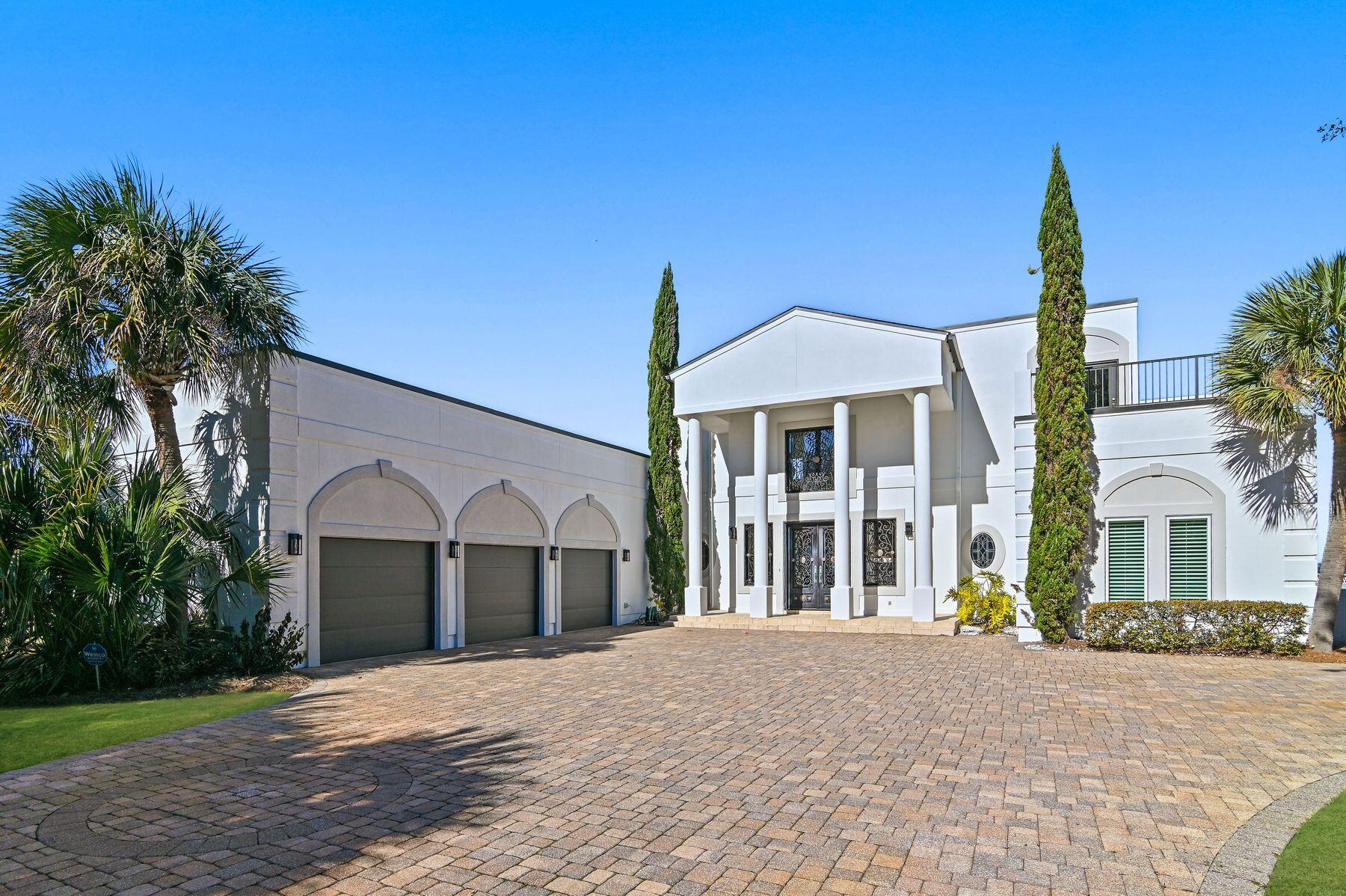 In the prestigious Emerald Bay community, this bayfront home epitomizes elegance and luxury. Positioned on a private cul-de-sac street, the property offers breathtaking views of the bay, accessible via a private pier leading to a hydraulic lift boat dock. The home's grandeur is immediately apparent upon entry, with a dramatic circular staircase and an enormous living area that seamlessly flows into the dining room, overlooking the large swimming pool. This residence boasts two living areas, with the second floor versatile enough to serve as a fifth bedroom, thanks to its closet space. Each bedroom offers stunning bay views and opens onto expansive balconies, perfect for entertaining or private enjoyment. The master bath is a highlight, featuring a corner whirlpool tub and extra-large walk in shower. Granite countertops grace all cabinets, while marble inlaid accents on ceramic tiles add a touch of sophistication to the baths. The bedrooms are comfortably carpeted, and the kitchen is equipped with stainless steel appliances and uplighting on cabinets. The home's design maximizes natural light and views, with large 8-ft. doors and 12-ft. ceilings on the first floor. Recent updates include repainting the master bedroom wing, repainting all the living and dining area and upstairs hall and bedroom, replacing A/C units and hot water heaters, and resurfacing all exterior second-floor balconies. The seller has also replaced all dryvit stucco with new hard coat and repainted the exterior white last year. The property's amenities are as impressive as its interior, featuring a gunite swimming pool with remote-controlled lighting and a wood dock with a hydralic Lift for a bay boat cruiser. Two jet ski lifts are also off the Dock. The 8-ft. metal front doors create a dramatic entrance, allowing sunlight to flood the main living space and dining room. The oversized three-car garage includes extra storage areas. All stainless steel appliances and furniture convey with the sale, except a few select paintings. This home is an ideal match for those seeking a luxurious bayfront lifestyle in a golf course community, with ample space, numerous bedrooms and extensive storage options. The combination of privacy, elegance and breathtaking views make this Emerald Bay property a rare and coveted find.