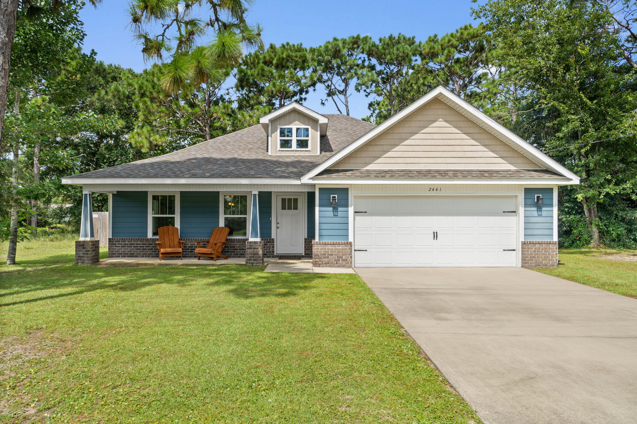 Welcome home to this impeccably maintained 2017 craftsman style home located on almost a half acre lot with producing orange and grapefruit trees in the backyard! Featuring 3 bedrooms plus a private office, this beautiful home has all the updates you've been looking for. Pull into the driveway and immediately appreciate the spacious front porch which leads inside to a fantastic open floor plan with hard surface flooring throughout all the common areas. The large living room showcases numerous windows for lots of natural sunlight and it's open to the eat in dining space and well appointed kitchen. The kitchen features granite counters with a functional island and hope up bar for seating, pendant lighting, and stainless steel appliances including a drop in stove and french door refrigerator. The master bedroom is a comfortable space with a trey ceiling and an en suite that has double vanities, a soaking tub, separate shower, and walk in closet. The other two bedrooms are nice sized with ample closet space, and a nice sized interior laundry room - washer and dryer will convey with the sale! Walking towards the back door on the left you'll find a private office which is a great bonus space. Outside you'll enjoy sitting on a covered back patio overlooking your expansive backyard. And they're not ready yet, but be sure to check out the producing orange and grapefruit trees where you'll love picking your own afternoon snack! The yard is fully fenced in with an irrigation system on a well for the front yard and half of the backyard. No HOA! Don't miss out on this fantastic home in a wonderful location close to Navarre's beautiful beaches and Hurlburt Field!