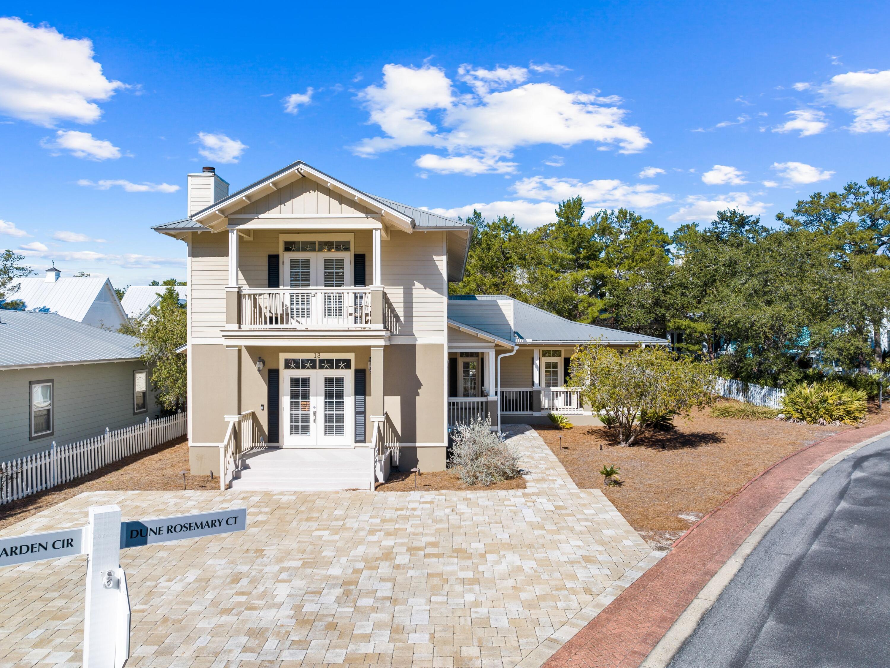Set on an oversized lot close to Seaside, Florida, this five-bed, three-and-a-half-bath home sleeps up to 11 guests. It incorporates a two-car garage, usable attic space, lots of porches and ample parking on the block-paved driveway. Neat features include updated bathrooms, built-in bunks (twin over queen bed) and new LVP flooring throughout. The open-concept kitchen, dining and living areas provide a sense of spaciousness whether you're enjoying a leisurely beach vacation or residing here full-time. A huge sectional sofa provides a natural space for socializing after a busy day at the pool or beach.  The well-appointed kitchen boasts stainless appliances, granite countertops, contemporary lights and updated fixtures. It also has a lengthy breakfast bar with wine cooler. The washer and dryer are tucked away in a generous laundry room and there's a dedicated office space. One of two master suites is on the first floor and has its own ensuite bathroom with garden tub. Upstairs, the second master has a sitting area, ensuite bath and a private porch for quiet escapes. Two further bedrooms, a bunk room and a second balcony allow everyone to find their own private space. Screened and open porches to the side and rear of the property create further areas for dining overlooking the paved barbecue terrace and partially fenced rear yard. The Cassine Village community has two pools, tennis courts and a private fishing lake. Days can be spent exploring the fitness trails by golf cart or bicycle or enjoying the nearby boutiques, cafes and attractions. Located just across from one of several beach access on 30A, the home is very convenient for sunset strolls, shelling and swimming in the balmy Gulf of Mexico. Nearby Point Washington State Forest also offers endless recreational opportunities including hiking and wildlife.