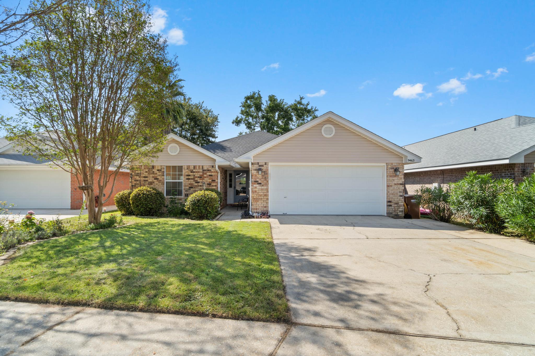 Welcome home to this perfectly located east Navarre all brick 4 bedroom home! Have peace of mind with a roof installed in 2019, and an HVAC and water heater that are both only 5 years old. Pull up to this adorable home and appreciate the extended parking slab (there's even room to park your boat!) and the tasteful landscaping is gorgeous in full bloom. Enter the front door and you'll appreciate the hard surface laminate flooring extending throughout the common areas with carpet in the bedrooms and tile flooring in the bathrooms. The split floor plan allows for master bedroom privacy, and you'll love the open concept with a kitchen and large dining area open to the spacious living room. The master bedroom has a great sized room with plenty of space for your king sized bedroom suite, as well as a walk in closet, and double vanities in the master bathroom. The other three nice sized bedrooms are on the other side of the house and share a full bathroom (with updated vanity). The interior laundry room is located off the kitchen and leads to the two car garage. Exit from the great sized living room and outside you'll find a fantastic secret garden-esque backyard with a massive covered back patio to enjoy and lovely landscaping with a raised flower/garden bed. Don't delay in making this beautiful home yours and enjoy a short commute to Hurlburt Field while being only minutes from Navarre's stunning emerald coast beaches!