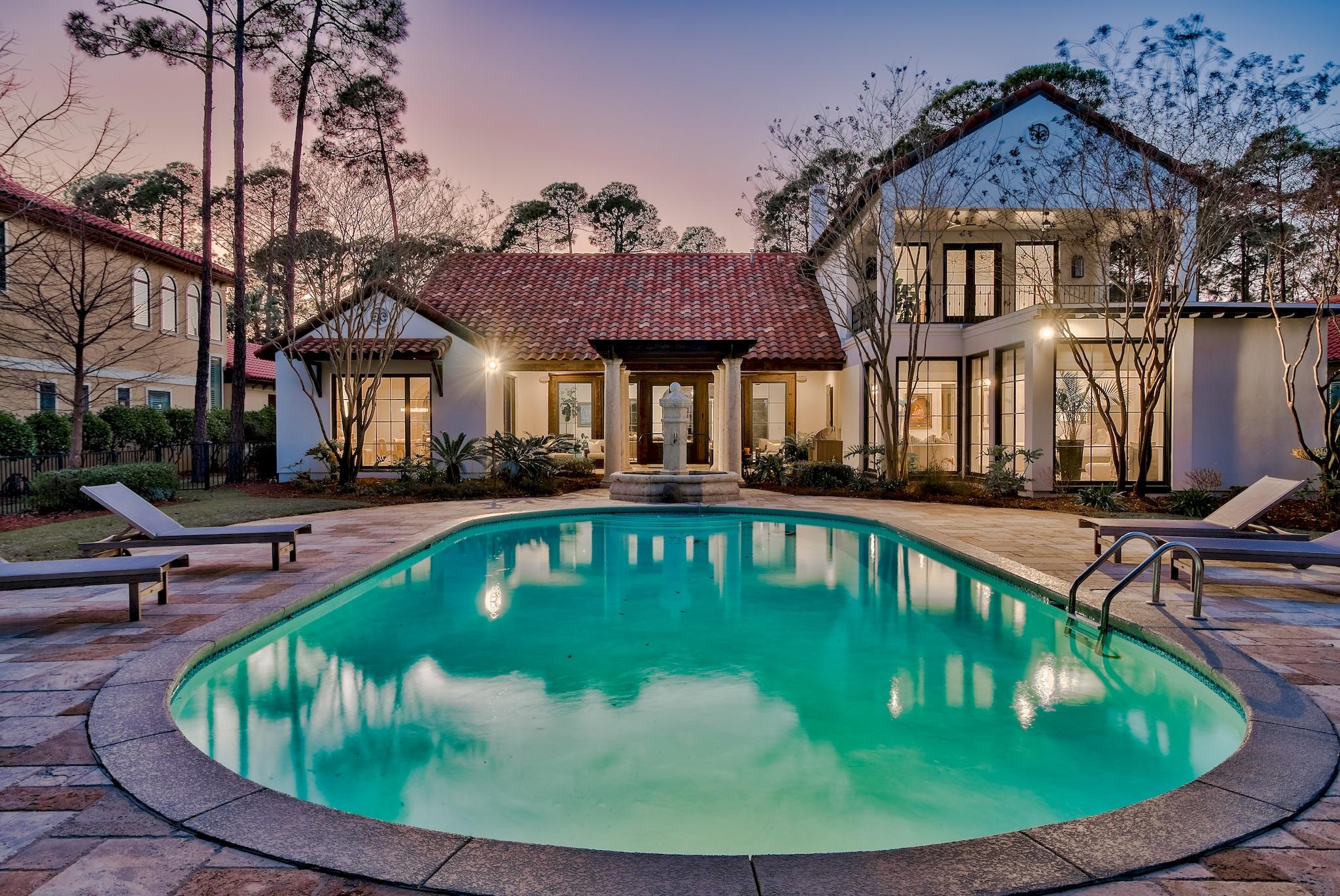 New Orleans Mastery meets Coastal Color in this fully and beautifully renovated Burnt Pine transitional home that captures lake and golf course views. Timelessly sophisticated interiors are intensified by 120-year-old reclaimed heart-of-pine, wide-plank flooring, dark-framed windows, solid cypress beams, wrought-iron accents, and limestone archways. Indoor allure blends seamlessly with back-yard immenseness that is highlighted by a 20' X 40' private pool. This 6,407-square-foot stucco, five bedroom, five bath home is the epitome of luxury coastal-contemporary design that both celebrates its natural surround and innovates the beachy locale. Sleek lines, organic materials, airy spaces, bold hue accents, and a wealth of sunlight define its signature style. The total renovation includes: complete kitchen and five baths overhaul; exterior restucco; pool resurface and retile; fireplace remodel; floor and ceiling updates, a reconfigured floor plan, designer lighting throughout, and addition of a movie studio. A private courtyard entry features an old-world fountain and tropical landscape integrating the outdoors into all main interior spaces. The chef's kitchen is a showpiece; its clean, classic lines, streaky marble countertops, limestone arches, orb pendant lighting, and blue shaker cabinets are stunning. Fish scale tiles mimic the gentle movement of the sea, while deep blue shades evoke the sky. Chef-worthy amenities include a butler's pantry with full-size wine refrigerator and appliance garage; Wolf professional range with dual griddle and ovens; professional size refrigerator; prep sink; and ice machine. The master suite is elegantly designed and opulently appointed with generous square footage, incredible views through floor-to-ceiling windows, a separate sitting area, a luxurious ensuite, double boutique-style closets, and an adjacent office. The master bath is separated into two separate vanity suites with an adjoining shower. A game room with beverage center and screening room provide entertainment for the whole family. The 3-car garage plus golf-cart bay includes a workroom and built-in cabinetry. Burnt Pine Golf Club is a highly sought-after gated community within the 2,400-acre Sandestin Golf and Beach Resort, offering a world-class tennis complex, private beaches, a 113-slip marina, and four championship golf courses.