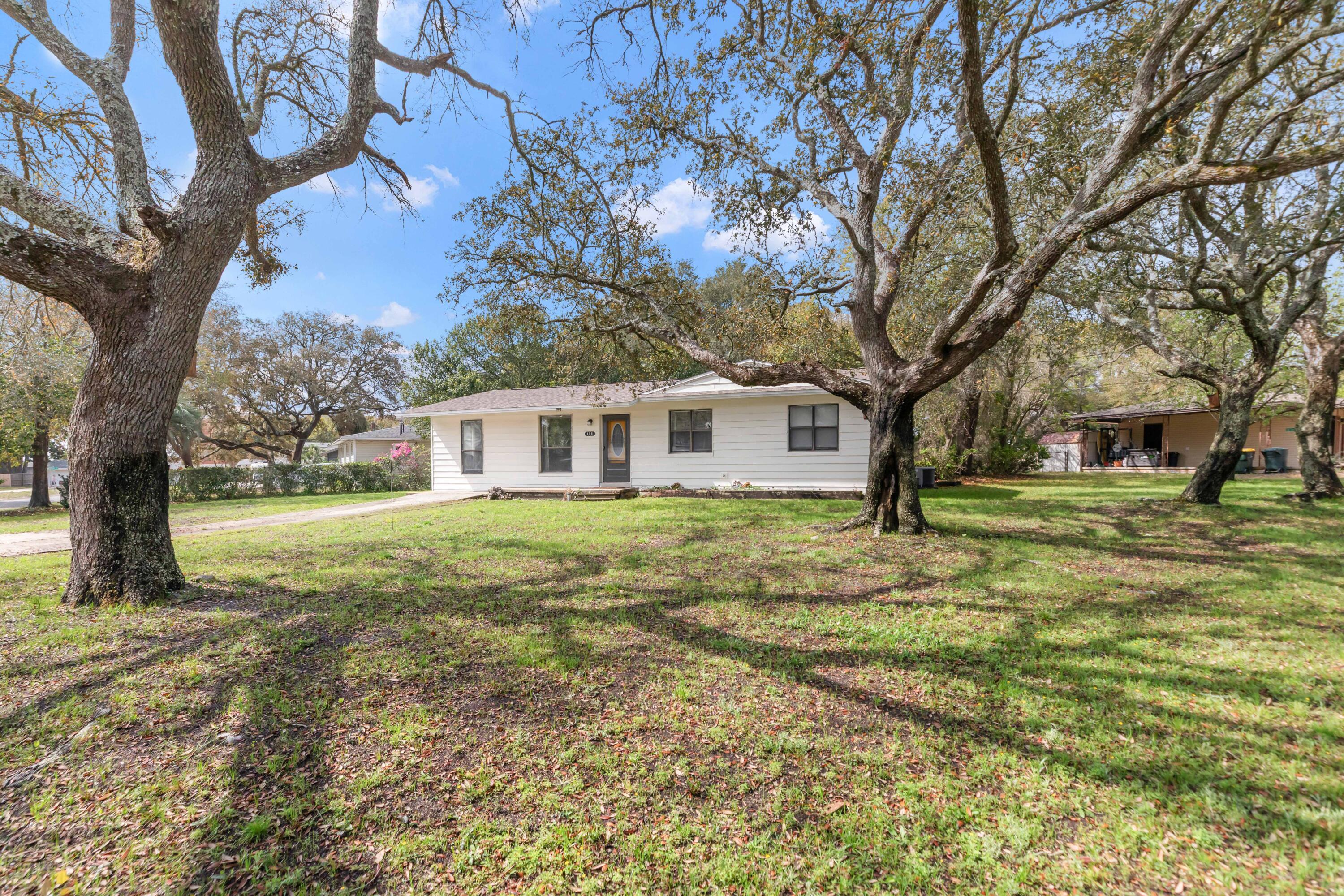 Welcome to this charming corner-lot cottage shaded by beautiful oak trees. This home has been thoughtfully updated with major improvements, including a full rewire, new roof, new HVAC system, and LVP flooring all completed in 2021. Bathrooms were tastefully remodeled in 2023 with ceramic tile flooring. The kitchen features a GE gas range/oven and Whirlpool refrigerator (2022), along with updated countertops and crown molding added in 2024. Additional upgrades include a newer screened porch and gutters. The open floor plan creates a spacious feel, complemented by a bonus space off the living room which can be an office, 2nd living room or other flex space.