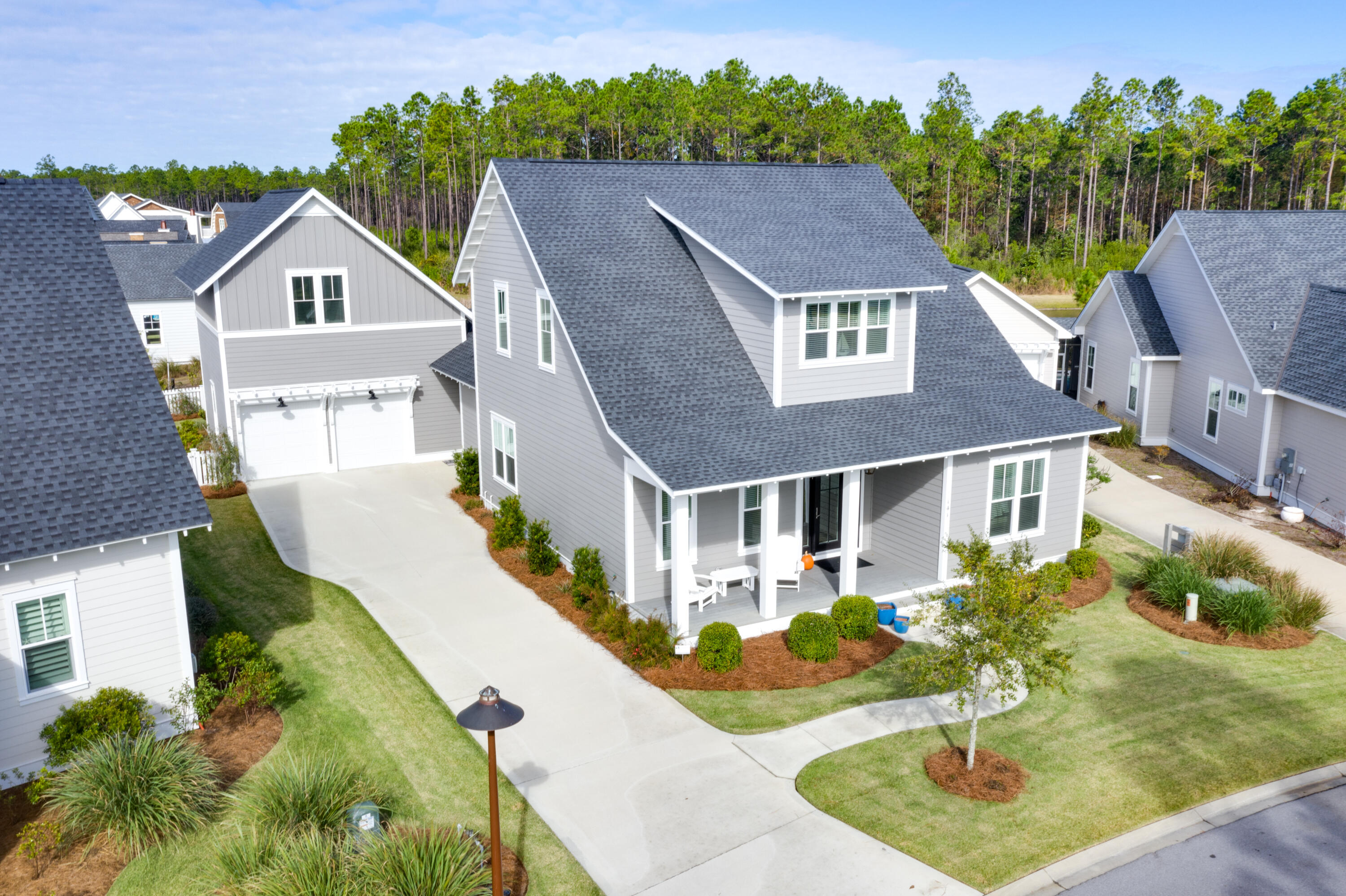 Meticulously maintained and beautifully designed Custom Home. Situated on the bend of a serene pond in the back and a community park in the front in a construction complete area of Origins, this is truly an incredible opportunity to own the quintessential Florida home. This home comes with a highly coveted St. Joe Beach Club Membership and approved DRB plans to add a pool in the private backyard! When you first walk in, you will immediately notice the ten foot ceilings, how bright, welcoming and eloquent this home really is. Every detail was obsessed over and the list of upgrades is longer than a summer night. In the master, you'll revel in the morning light as it soaks into the shiplap accent wall and pours into the gorgeous quartz floors and countertops of the master bathroom. Featuring upgraded Honeycomb marble flooring in the shower, quartz walls, a garden tub, dual vanity and an expansive walk-in closet. Across the hall in the guest bedroom, there is again a shiplap accent wall, an upgrade which has been implemented throughout the entire home. Upgraded basket weave tile in the showers as well as upgraded bathroom flooring, quartz countertops and Koehler toilets and sinks. In the main area of the home you're first greeted by a proper dining area and an expansive living area. In the kitchen there is upgraded cabinetry to the ceiling, quartz countertops, Thermador stove and dishwasher, Subzero fridge and Sharp drawer microwave. Upstairs there is an easterly facing bonus room or office space with two additional bedrooms with ensuite bathrooms on either side. However, if you're looking for somewhere more secluded for your guests, take a trip back downstairs, past the kitchen and laundry room and up the stairs to the carriage house. A private and self sustainable location with a full bath. You will also see a magnificent quartz wet bar with a built-in wine cooler. Out back, there is a large screened-in patio overlooking the pond with a stone BBQ area and a completely fenced in backyard. With a magnificently custom 2 car garage, ample driveway space, 5 bed, 5 bath and an unparalleled location, this is the ideal home for entertaining, big families or those who just simply love their space.

Watersound Origins homeowners are able to access the fitness center and seasonally heated community pool, as well as dock access at neighboring Lake Powell. Watersound Origins also connects to the Panama City Beach Conservation Park via a 5-mile long trail. Watersound Origins offers plenty of options for the nature and beach lovers alike! Spend your days kayaking, paddle boarding, biking, running or walking along the Watersound trail. Located a short distance from Scenic Highway 30A there are endless dining, event and local shopping options and attractions.