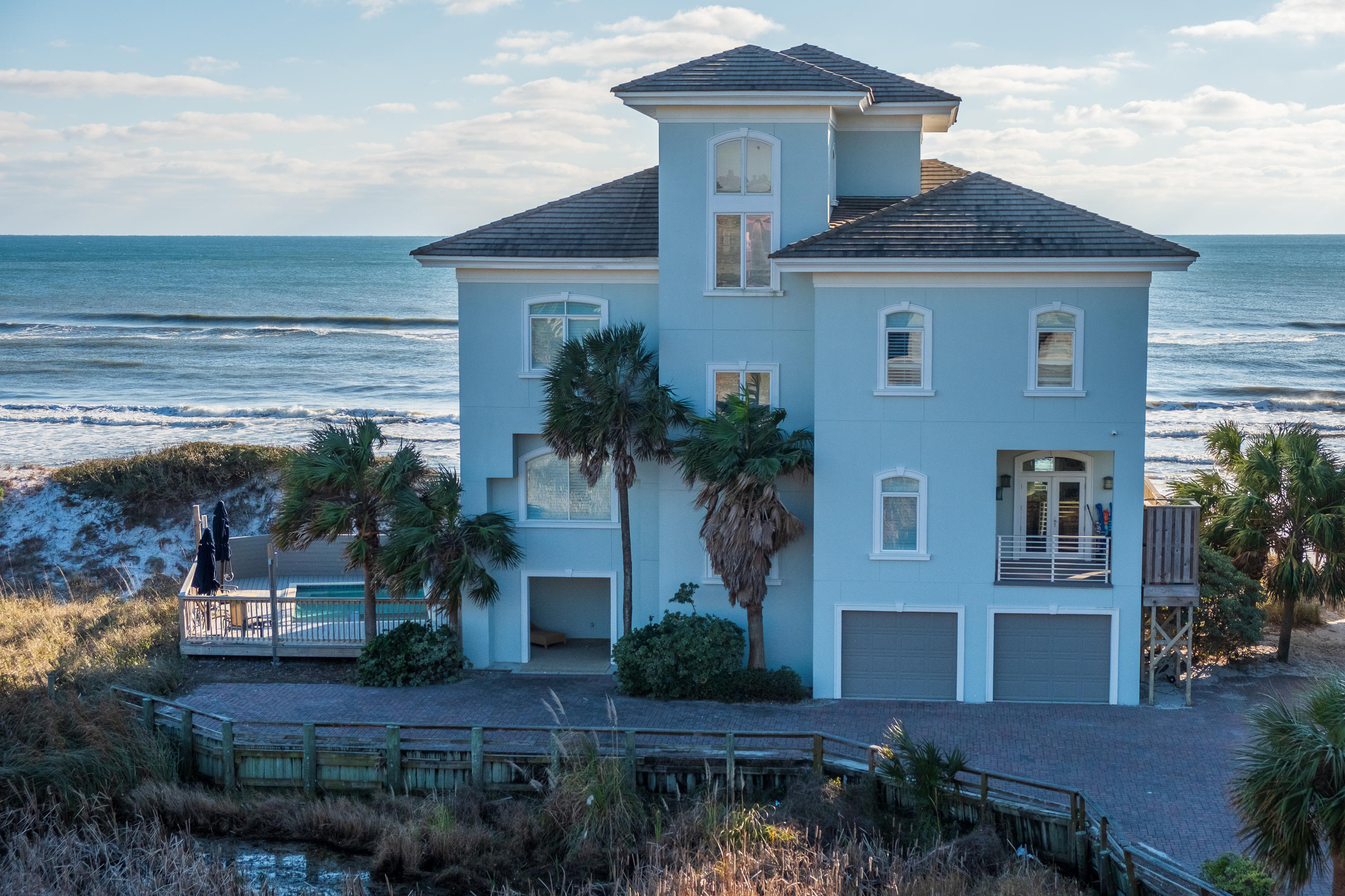 Entering the small Gated Beach Community (only 4 lots), you'll find a Private Beachfront Home located just steps from the Crystal White Sand and Emerald Coast Waters, with 100.19 FT of Beachfront & Total Approx. Living Area of 6,639 Sq Ft ! This Beachfront Home is equipped with an Elevator to take you from your spacious 2 car Garage to any of it's Four Levels, including a trip to the top, towering over the amazing Gulf of Mexico. These truly Spectacular views from each Floor offer the intimate & natural inclusion to all surrounding with a remind that you really are at the Beach. All 5 Bedrooms have complete views of these whispering Gulf Waters. Enjoy Balconies on all upper Levels including a private out-door Shower and a Level 1 heated Pool w/Hot Tub with a surrounding open deck. The 18" Travertine Tile found throughout the Home is perfectly suited for the Beach and stands out against the high end finish woodwork. This striking Kitchen contrast surely delivers with the Stainless Steel Kitchen appliances (including a multiple gas burners, double oven & icemaker) accompaniment. Especially so, when enhanced further by a nuanced retro Lucite Countertop, elaborate Granite Countertop(s), the totally unique Tiger wood cabinets & modern designer lighting. The comfortable and relaxed flow of energy continues throughout the open living/dining area experiencing the combination of modern amenity uniting with a an overwhelming view of the stark free nature from every angle. A marble framed gas fireplace completes this warm yet powerful space.  Considering also that the Home has basically multiple Large Master Bedrooms, each with it's own intimate View & closeness to the vast expansions of the Gulf.  Also enjoy a wetbar & wine fridge in the roomy Family Room on Level 3 & a private Kitchen area in the Bonus Room Tower on Level 4.  Seven Full Bathrooms throughout (including one with handicap access on Level 2) offer more of the clean spacious luxury with separate glass showers, pedestal sink, bubble & jetted tubs and marble. This Home has multiple high efficiency heating & cooling systems, spray foam insulation throughout & a special ultra-violet lighting in the air ducts. Exterior is fiberglass reinforced concrete stucco with a tiled roof.  Nestled behind the Dune, the Broad Footprint that this Home was built upon and it's over 100Ft of Beachfront clearly enables it to realize its full potential...to compliment the free modern expression of design with a true awareness of nature's great wonder that is the Gulf and it's Beach.  It is this lofty perch that sets this Home above and apart from it's Neighbors....it's truly a great place.  The Huge Rental Income Potential is quite obvious.  The Central proximity of this Property to everything Scenic 30-A gives it a unique advantage of convenience to any GulfPlace & Seaside events, Grayton Beach fishing, YOLO Rentals, SRB Club Golf, Grand Blvd. Shopping, Nearby Restaurants & Pub Galore etc.  With enough spacious Bedrooms & full Baths to comfortably accommodate Large Family Vacations, Reunions & Wedding Guests.   
Great Memories Begin Here !