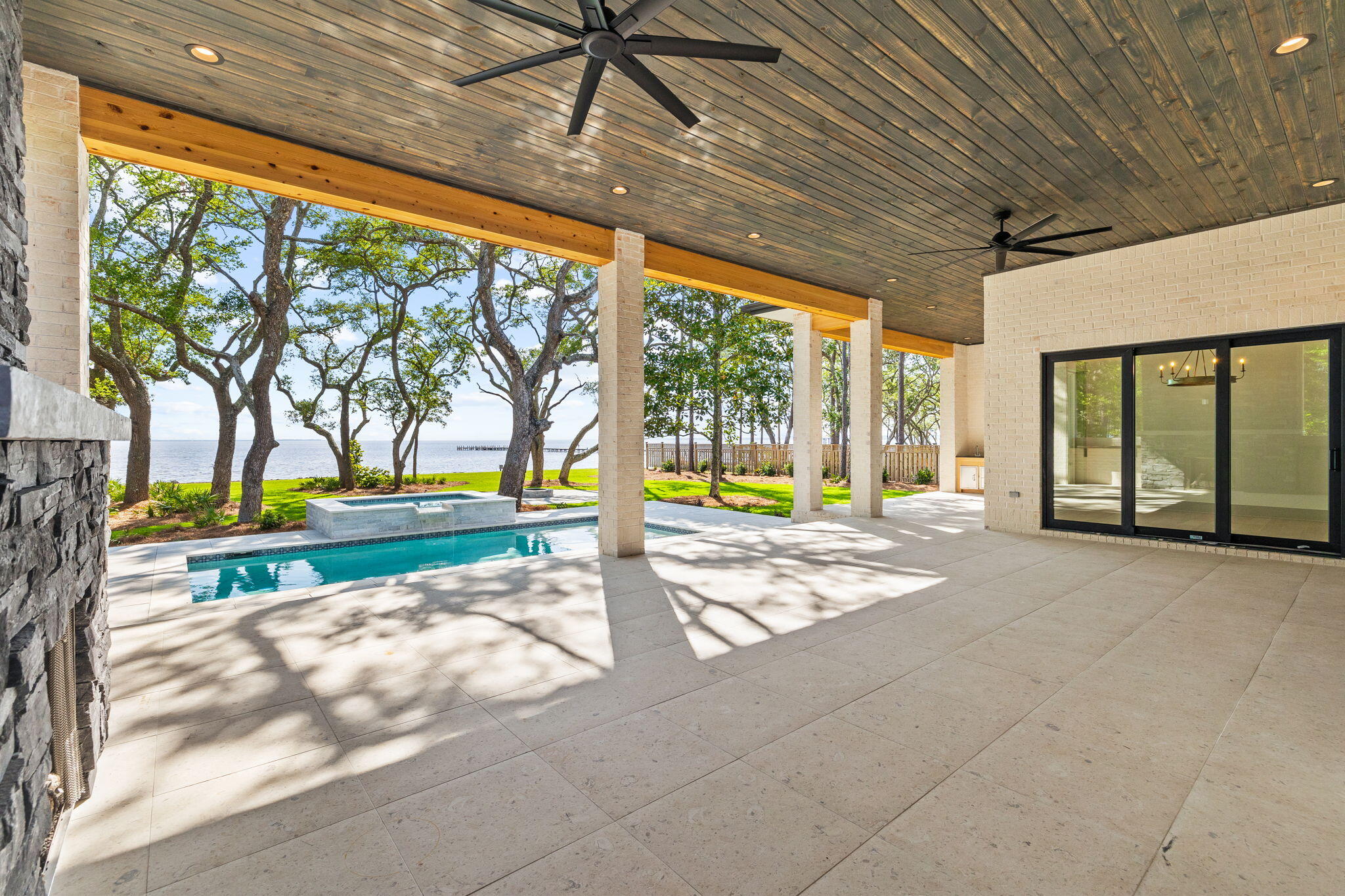This custom Bayfront home in Steamboat Landing at Hammock Bay is presented by Simmons Custom Home Builders. They are proud to share this 2,964 sq ft home on the Choctawhatchee Bay with stunning views for days. The ½ acre lot includes a new seawall with riprap in place on the oversized lot with 117' of water frontage, 3 car garage, private pool & hot tub and meandering rock pathways under the 100-year Oak trees to your own private dock. Living easy in this sprawling 4 Bedroom, 3.5 Bath ranch with Primary waterfront suite with double closets, freestanding tub, double shower head shower with private entrance to the covered waterfront porch. On the opposite side of the home, you will find another waterfront guest room, 2 additional bedrooms, two full baths, a half bath and a large laundry room. The heart of the home with its 12' ceilings and open floorplan make entertaining a joy. Double siding glass panels give way to an oversized covered porch with fireplace, and summer kitchen all overlooking the private pool & spa and the Choctawhatchee Bay. Take the stone path under the oaks to the firepit and use the allowance to build your priviate dream dock. Enjoy all the privacy you desire along with the ability to be a part of the magnificent development of Hammock Bay just outside your gated neighborhood. Hammock Bay amenities include, Sports Complex, Picke Ball, Tennis, Basketball, Clubhouses, Fitness Center, Several Pools, Sidewalks & Walking Trails, Dog Parks, New Brewery & Food Truck Court and the New Freeport Middle School. All of this within minutes to the Beaches of South Walton and all that Scenic Hwy 30A has to offer.