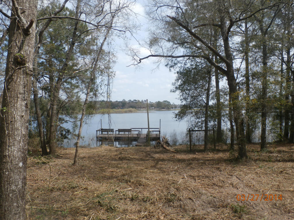This is a beautiful acre in a country setting on Kings Lake This property has a spacious dock with water piped to it from the home site, public water,septic tank and power pole. We have not given any value to the septic tank. PROPERTY TO BE SOLD ''AS IS''.
