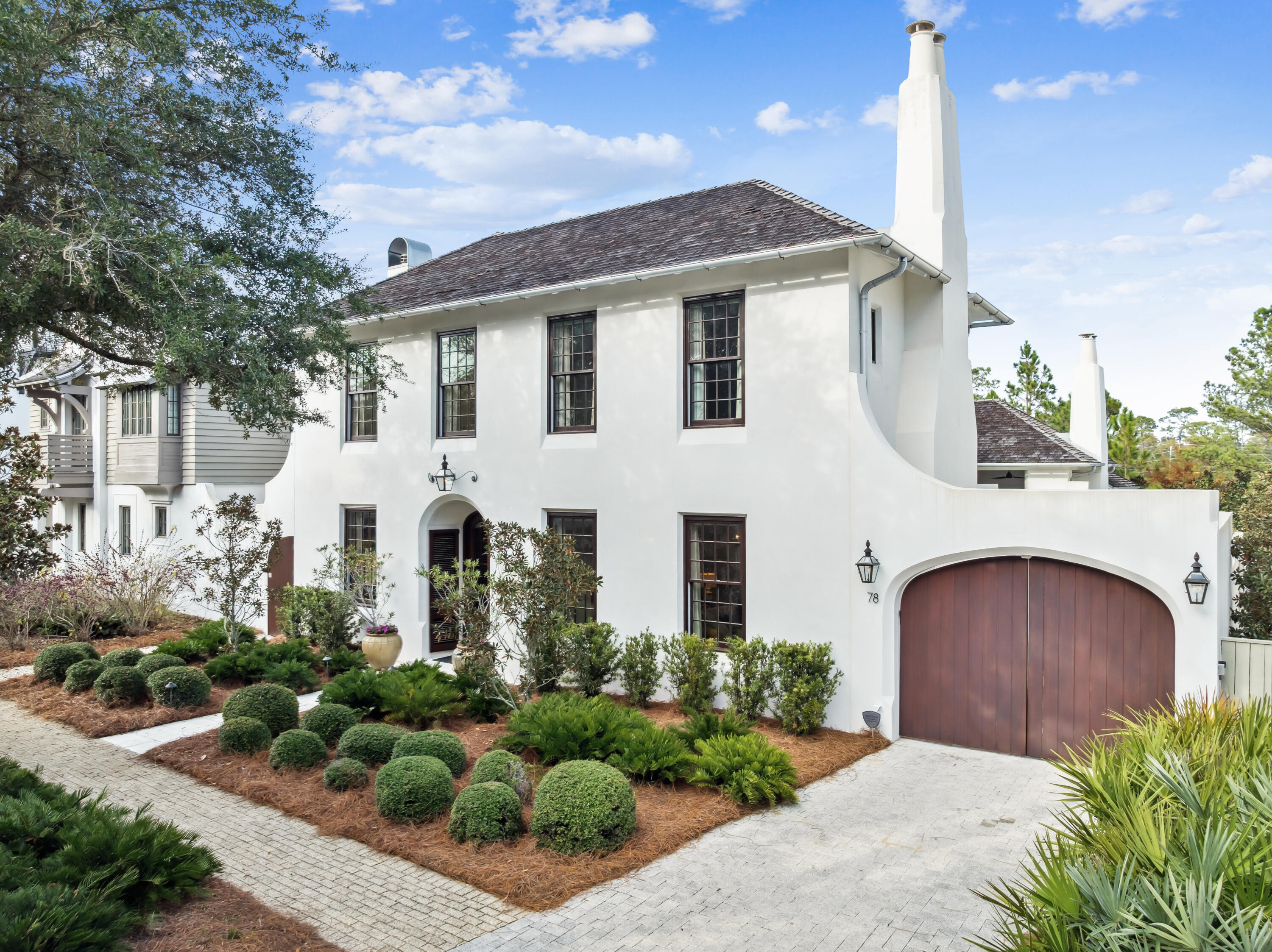 Tucked behind a graceful arched drive and lush courtyard, this Rosemary Beach home delivers the kind of refined privacy that feels like a true escape, whether you are living here full-time, spending seasons by the coast, or offering it as a high-end rental.

Crafted in 2015 by Benecki Homes, the residence blends Mediterranean elegance with modern livability and comes FULLY FURNISHED. Step inside to soaring eleven-foot ceilings, peacock paver floors, and rich architectural detail at every turn. The main level opens seamlessly to a private courtyard and a patio off the primary suite, complete with a tranquil water feature, while a climate-controlled two-car garage rests beneath a separate carriage house. Mediterranean influences continue throughout the property with hand-troweled Venetian plaster, wrought iron balconies, a recessed entry, and arched mahogany doors that frame the pool and courtyard beyond. Designed by Melanie Turner Interiors and featured in Atlanta Homes and Lifestyles, the interior reveals soft textures and a coastal sophistication that feels inviting and warm.

The kitchen is truly a showpiece, created for both chefs and entertainers. It features natural limestone counters, a Wolf range, dual Sub-Zero refrigerators, two Asko dishwashers, and beautifully tailored cabinetry. Gather around the oversized island or beneath the statement candelabra in the dining space. A hidden bar with underlit shelving and a nearby wet bar keeps everything flowing with ease.

Two primary suites, one upstairs and one on the main level, each offer freestanding soaking tubs and walk-in showers that create a spa-like retreat. The home's Control4 smart system makes every detail intuitive, from lighting and sound to security and media.

Outdoors, the covered loggia invites both slow mornings and lively evenings. Enjoy the grand fireplace, the TV setup, and the sparkling heated saltwater pool just steps away.

All of this is set within Rosemary Beach, one of 30A's most coveted coastal communities where cobblestone streets, gas-lit walkways, and European-inspired architecture blend with the relaxed rhythm of the Gulf.