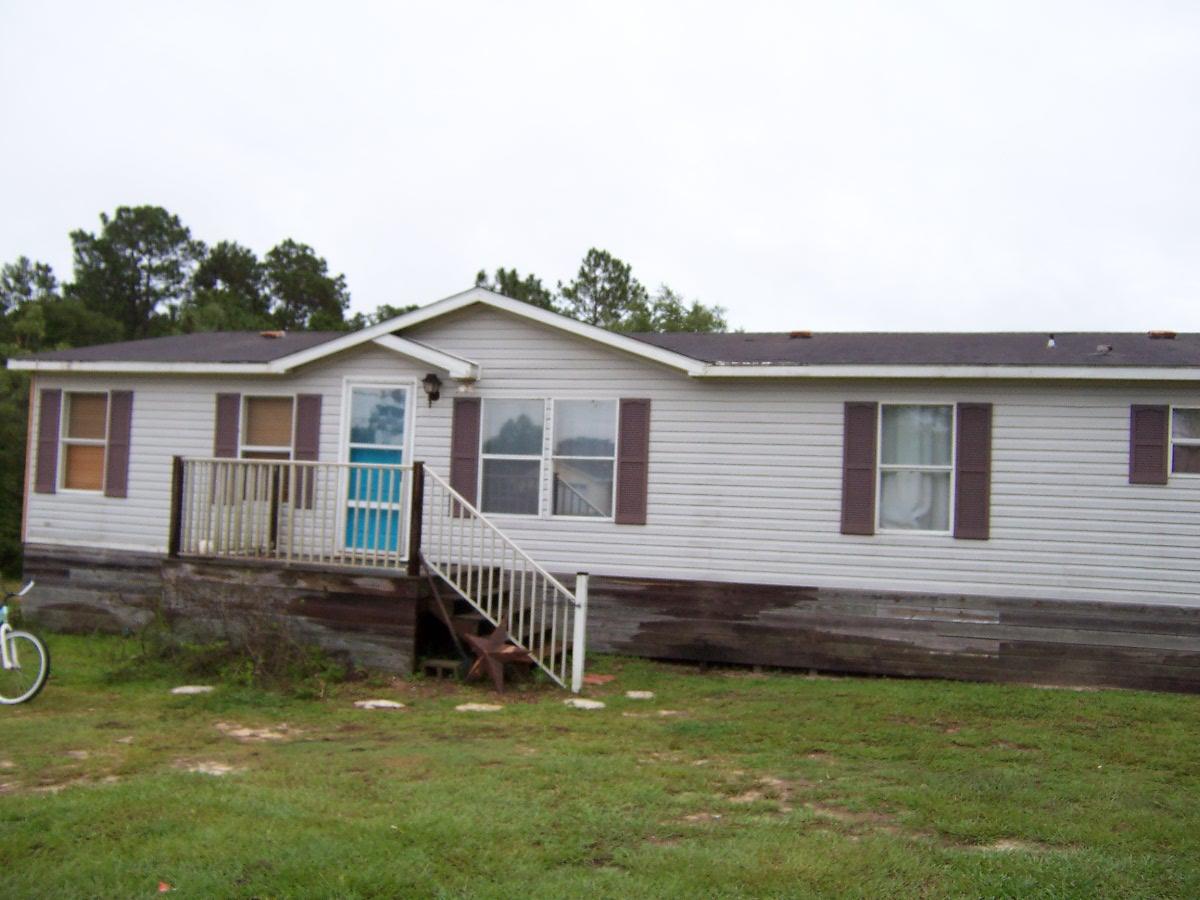 Great location in good neighborhood only 5 minutes from Walmart. Large 4 bedroom 2 bath doublewide on over an acre on a paved road. The home has many updates and features granite countertops, new floor coverings and new paint, 2 living areas, large kitchen, huge master bath, fireplace, and large back deck and storage building.