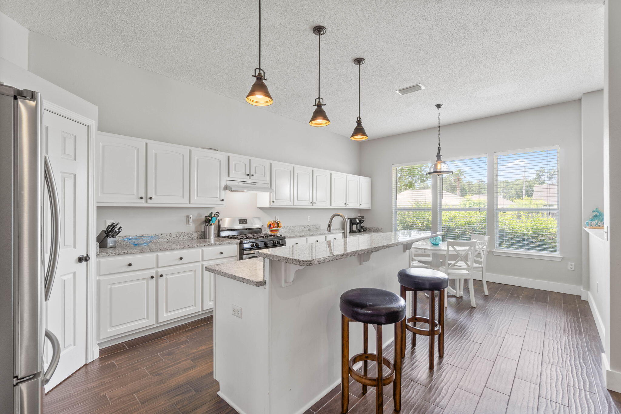 Welcome home to this conveniently located east Navarre home around the corner from the Navarre Youth Sports Association and Navarre High School, just minutes to Navarre's beautiful beaches, and a short commute to Hurlburt Field! Have peace of mind with a new HVAC just installed June 2024, a new roof November 2022, and a water heater replaced in 2020. No flood insurance required and no HOA! Pull up in the driveway and appreciate the well cared for landscaping guiding you to the covered front porch and updated craftsman style front door. Enter inside and you will fall in love with this massive open floor plan with stunning wood look tile extended throughout all the common areas with updated baseboards and soaring ceilings. In addition to a massive living room there's also an open formal dining room/flex space as well as an eat in space in the spacious kitchen. The kitchen is a fantastic space with a TON of cabinet and counter space, drop down pendant lighting, stainless steel appliances (check out the gas range!), newly installed granite counters, a walk in pantry, and a large functional center island. This Whitworth Builder's home also has an amazing primary bedroom that features not just one, but TWO large walk in closets! The bathroom also showcases double vanities granite counters, new undermount sinks and new faucets, a soaking tub, walk in shower, private water closet, and wood look ceramic tile flooring. All four bedrooms had new carpet installed less than two years ago! The split floor plan has the other three nice sized bedrooms on the other side of the house with ample closet space and a shared full bathroom between them. The two car garage has a beautiful floor that's been epoxied and sealed, and the fully fenced in backyard is a great space to enjoy with an irrigation system on a private well. Welcome home!