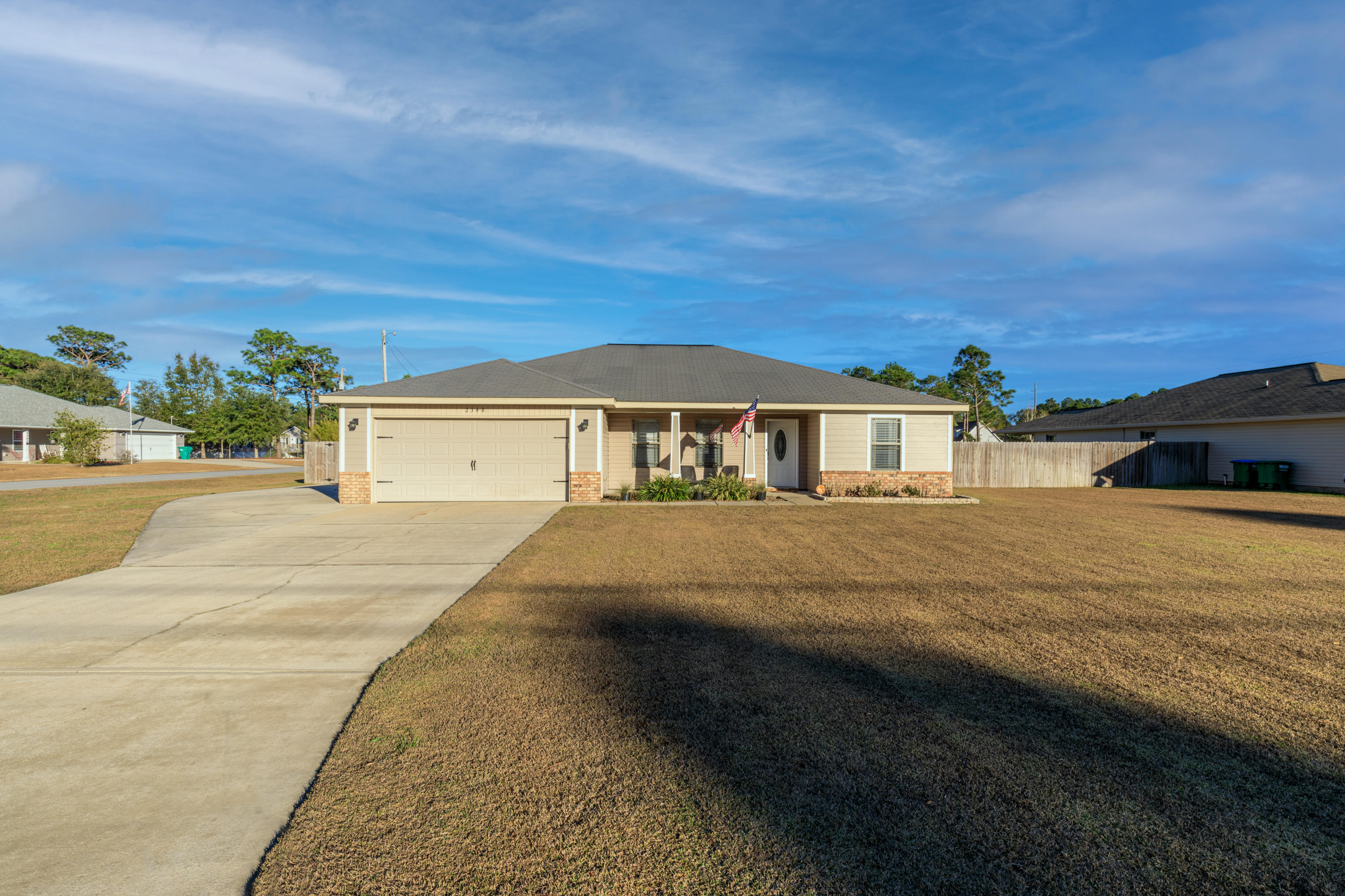 Welcome home to this updated and move-in ready home on a large corner lot with no HOA and a short commute to Hurlburt Field! The 3 bedroom/2 bathroom split floor plan home is fully fenced in with an expansive backyard and double gate access (bring your boat!). This home offers wonderful curb appeal, with brick and hardy board front exterior featuring tapered posts and a covered front porch. Entering the home you will appreciate the open flow to the spacious family room, dining area, and kitchen. The kitchen boasts an island that also doubles as a breakfast bar, upgraded stainless steel appliances, brand new granite countertops, upgraded custom wood cabinetry with plenty of countertop and under cabinet lighting. The spacious master suite features a trey ceiling with a master bath with a  double vanity and great sized walk in closet. The interior laundry is on the side of the master, and on the other side of the house you'll find two comfortable bedrooms and a shared bathroom. Enjoy upgraded features like crown molding and recessed lighting, and be sure to check out the list of seller updates. You'll love being close to Navarre's beautiful emerald coast beach and the best of what Navarre has to offer. Don't miss out on this gem!
