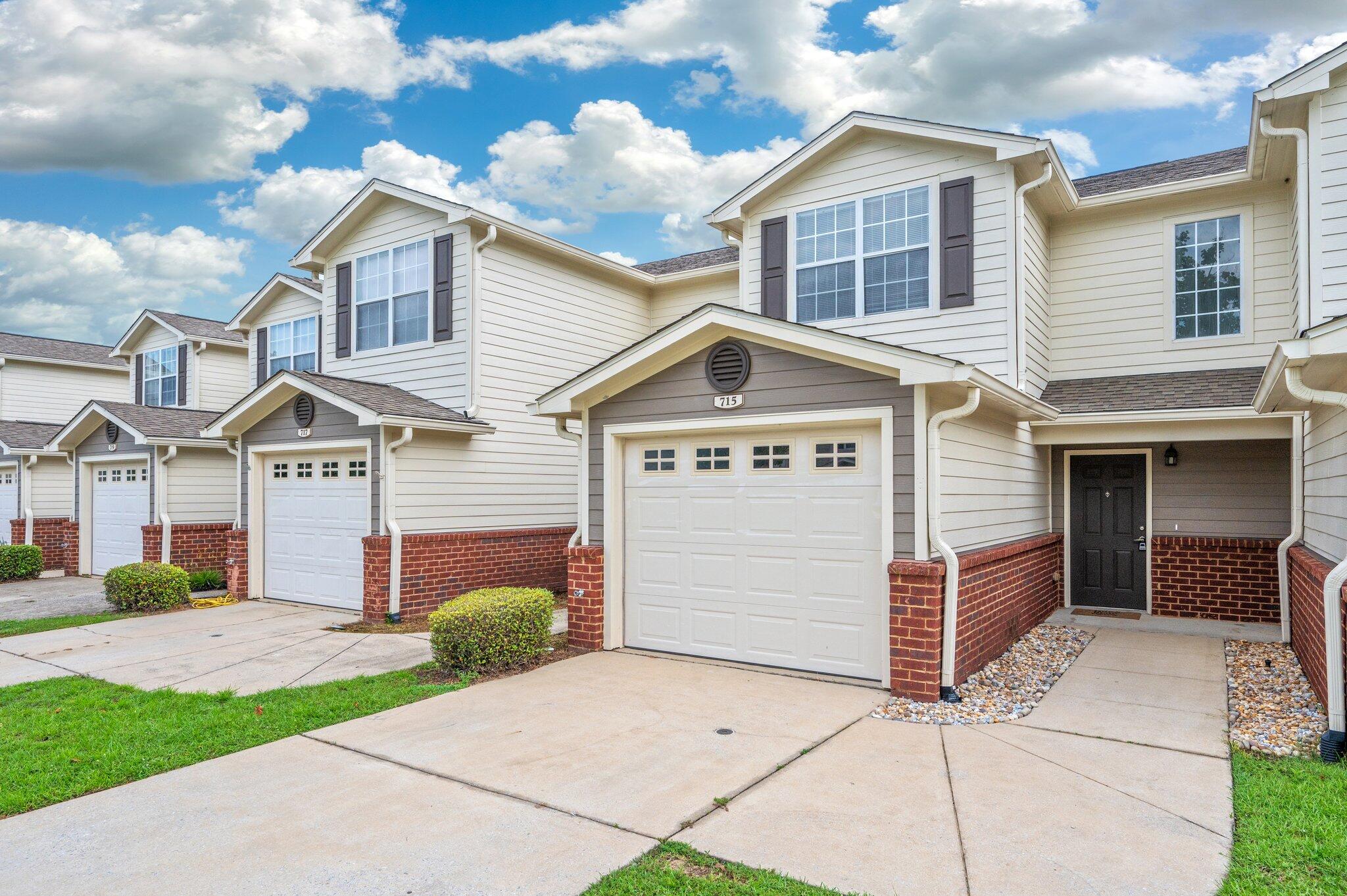 Welcome to this charming two-bedroom, two-and-a-half bath townhome located in the heart of Crestview. The main level features durable ceramic tile flooring throughout, a convenient half bath, laundry room and a functional galley kitchen with maple cabinetry and a peek-through window that opens to the combined living and dining area—perfect for entertaining. French doors lead to a landscaped backyard with a peaceful view of the pond. Upstairs, both bedrooms offer private en suite bathrooms with bath-shower combos, spacious vanities, and walk-n closets with newer carpet. This charming townhome also includes a one-car garage for added storage and security. This well-maintained community offers fantastic amenities, including a swimming pool, clubhouse, and playground ideal for enjoying Florida living at its finest!