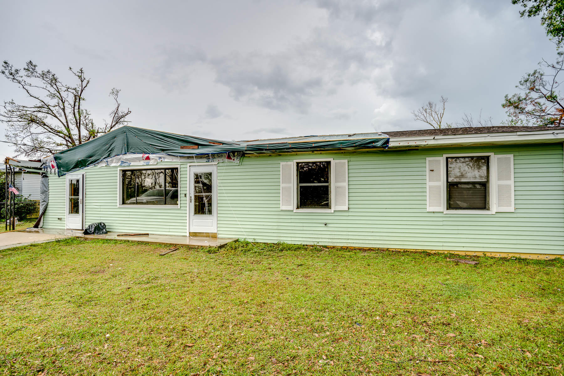***Attention Investors***Cinderblock under vinyl siding. Good location! Nice size lot! Plenty of space for everyone! The carport was converted into a bonus room, that could easily be used as an office, extra bedroom, den, playroom or even converted into a garage. There was also another addition added for extra living space! With some TLC, the home would make a great primary home, or rental. The house was damaged in the hurricane, and needs some work. Being sold ''As Is'' with right to inspect, and Cash only. Bring an offer! Won't last long! All measurements approximate, please verify if important.