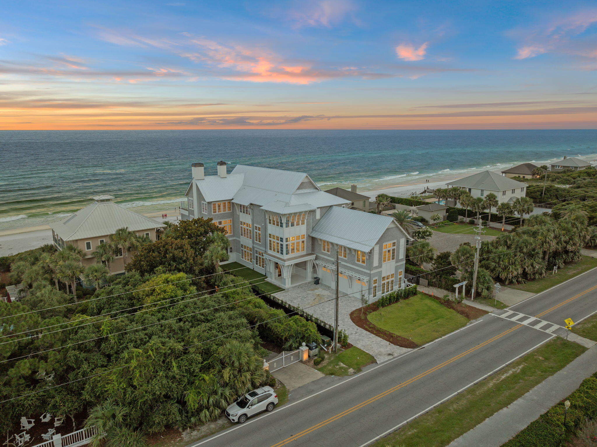 This is 4603 W County Hwy- a brand new, secluded beach home that boasts 9BR/9BA and is situated right on the Gulf of Mexico with 85 feet of private beach frontage. The lush .6-acre promontory has panoramic views of the Gulf and offers a rare opportunity for you to own your own piece of paradise. No expenses were spared, featuring over 11,000 sf of artfully designed living space within the exclusive scenic gulf side neighborhood on 30A.    Enter the home through the beautiful formal entry with wood flooring that leads to the open sun-drenched great room. Here you will find nearly every room on the main level of the residence opens up to the outdoors, ideal to enjoy an intimate outdoor setting. Partake in alfresco festivities on the covered patio that includes an outdoor kitchen rich with organic hues and boasting a built in stainless steel grill. Step out back to the open air patio flooded with sunlight and a refreshing swimming pool and thriving greenery and colorful flora. The manicured grounds and palm trees create the perfect setting for peaceful private wanderings, all while listening to the sounds of the nearby waves. Side yard complete with green area and bocce ball court. Each floor of the residence is designed for easy living, offering a relaxed, versatile layout and timeless design to suit your living style. Two spacious kitchens, grand living rooms, and floor to ceiling sliding glass doors provide a private, light filled oasis and seamless indoor/outdoor living that keeps you immersed in nature and the Emerald Coast climate. Natural light saturates the open plan kitchen with custom cabinetry, crisp white marble countertops, and top of the line appliances ideal for the at-home chef. Off of the kitchen you will find a full butler's pantry and wine room. The primary suite is located on the third floor and offers a separate den area with peaceful gulf views as well as a spa-like bathroom with luxury finishes and dual walk-in closets. You will also find a full home gym and spa on the third floor, as well as a theater room. This home truly has it all.