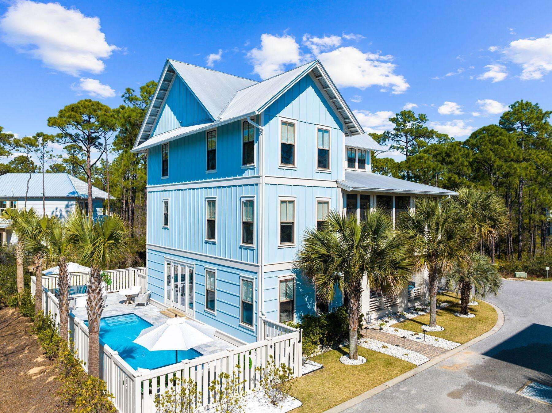 Newly enhanced with a private pool, this stylish beach home offers elegant finishes in a beautiful wooded setting on the coveted east end of 30A. Immerse yourself in the natural surroundings as hardwood flooring and hand-hewn beamed ceilings set the tone for a tranquil and elegant ambiance. Floor-to-ceiling windows and doors seamlessly connect the interior with the outdoors, leading to the screened-in wraparound porch, ideal for alfresco gatherings and relaxation by the porch's fireplace.  Interior features include custom light fixtures, exquisite décor and furnishings, and high end trim details throughout. The heart of the home, the spacious kitchen, exudes luxury with cool white quartz countertops, complemented by Kohler fixtures and KitchenAid stainless appliances. The open layout also features a comfortable family room on the first floor that opens directly to the private pool area, surrounded by the property's lush landscaping, enhanced by extensive lighting and irrigation. With five beautiful bedrooms, and a built-in bunk room, this residence offers ample space for family vacations and large-scale gatherings. The community's amenities include tram service to the private community beach access complete with chair set-up, ensuring ultimate comfort and convenience for enjoying days at the beach. The home is a casual stroll or bike ride into Seacrest, Alys, and Rosemary Beaches which offer a delightful selection of restaurants, shops, and entertainment, further enriching the coastal lifestyle experience.