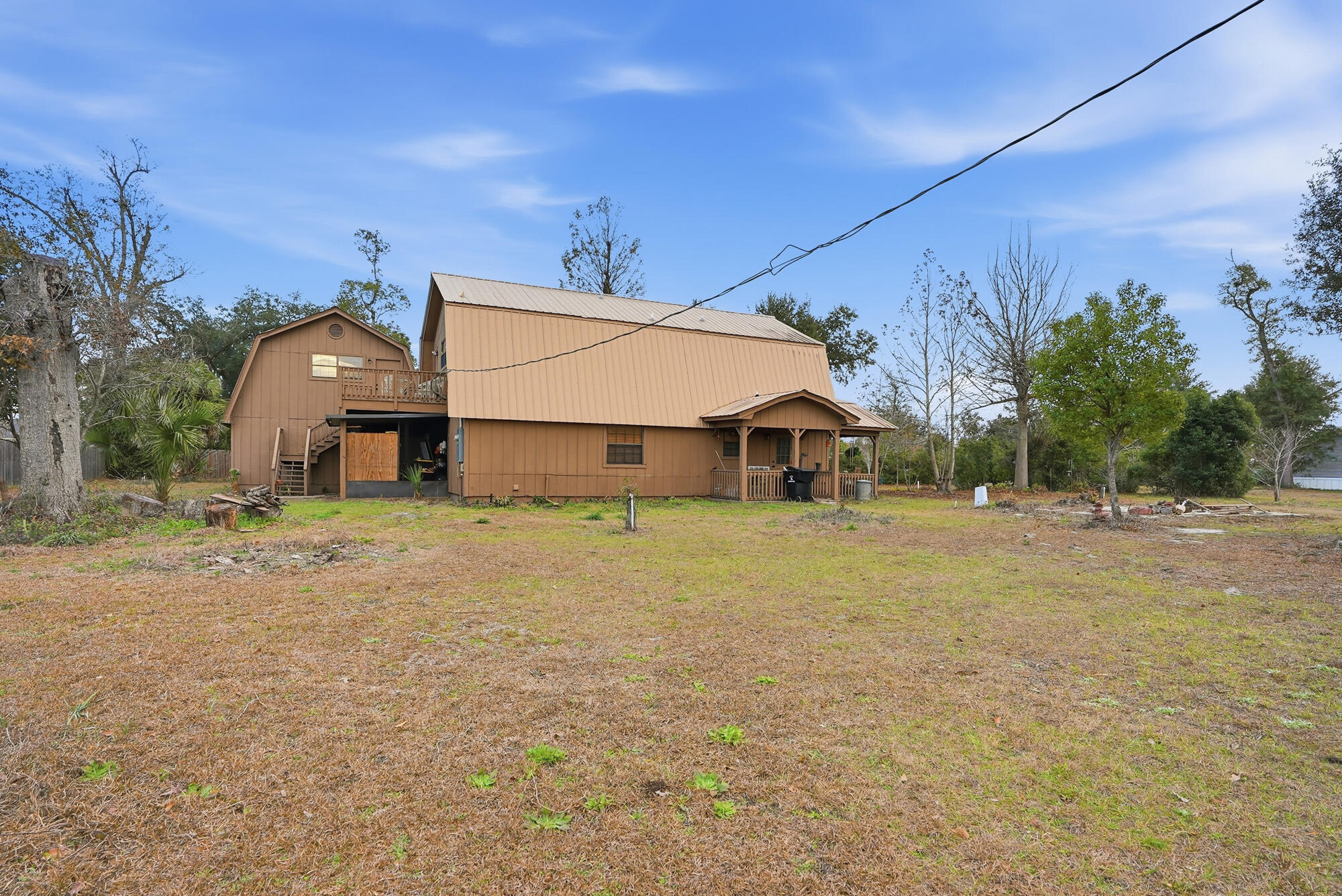 Welcome to Phillips Lane - a quiet, well-located gem in the heart of Panama City.  This inviting home offers a comfortable blend of everyday functionality and Florida charm, perfect for full-time living, a second home, or an investment opportunity.  This 2 bedroom, 2 bathroom home sits on almost a full acre of land and has two additional rooms without closets.  Primary bedroom is onthe second floor and features a private balcony from which to enjoy calming views of the surrounding area.  The Primary bathroom as double vanities and a walk-in shower.  There is another full bath with a tub-shower combination & a single vanity.  There is also a loft space above the two car garage that would be perfect for a studio apartment, craft area or storage space.  Furnishings can be sold too if desired