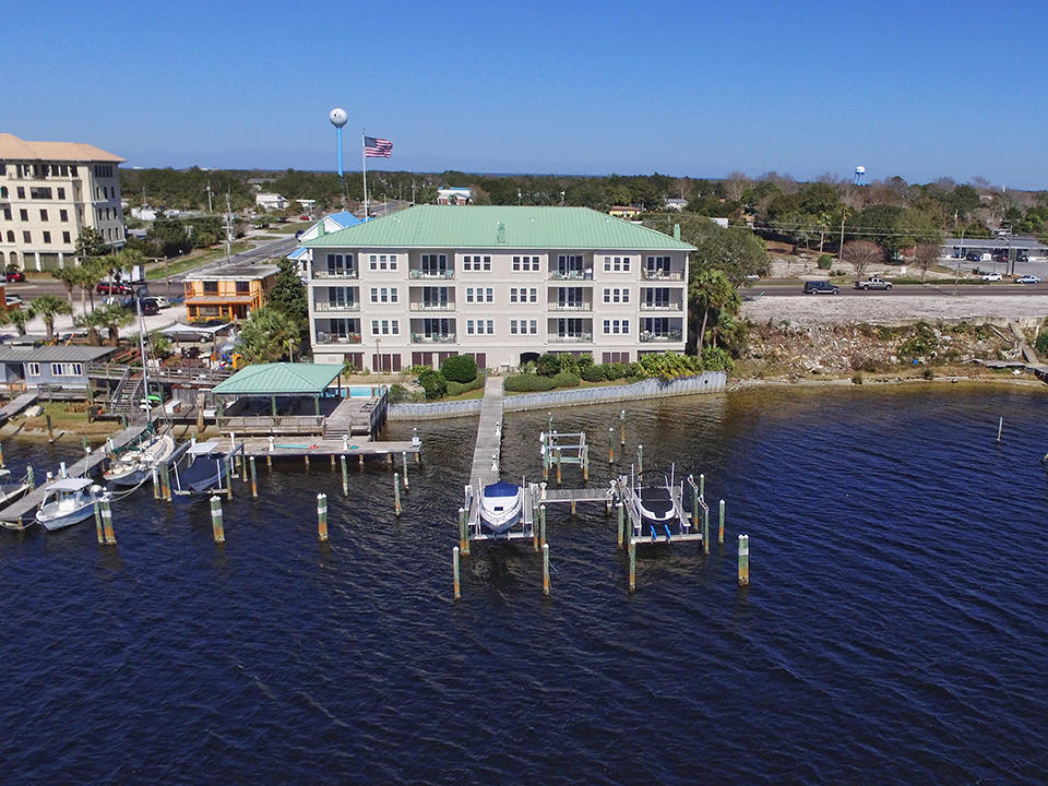 Beautiful corner penthouse overlooking Destin Harbor with views of East Pass, Holiday Isle and the Gulf of Mexico. This top floor unit includes 3 large bedrooms, 3.5 baths, a gas fireplace, covered patio, 12 foot ceilings, travertine flooring in main living areas, granite countertops throughout as well as a deep water boat slip! The open concept living, dining, kitchen and bar areas provide the ideal space for entertaining. The fully equipped kitchen includes Sub Zero and Viking appliances. Just off the kitchen is an oversized laundry room with storage. The harbor front master suite features large windows with beautiful views of the harbor and Holiday Isle, access to the covered patio, and a large master bath with walk-in shower and whirlpool tub.
