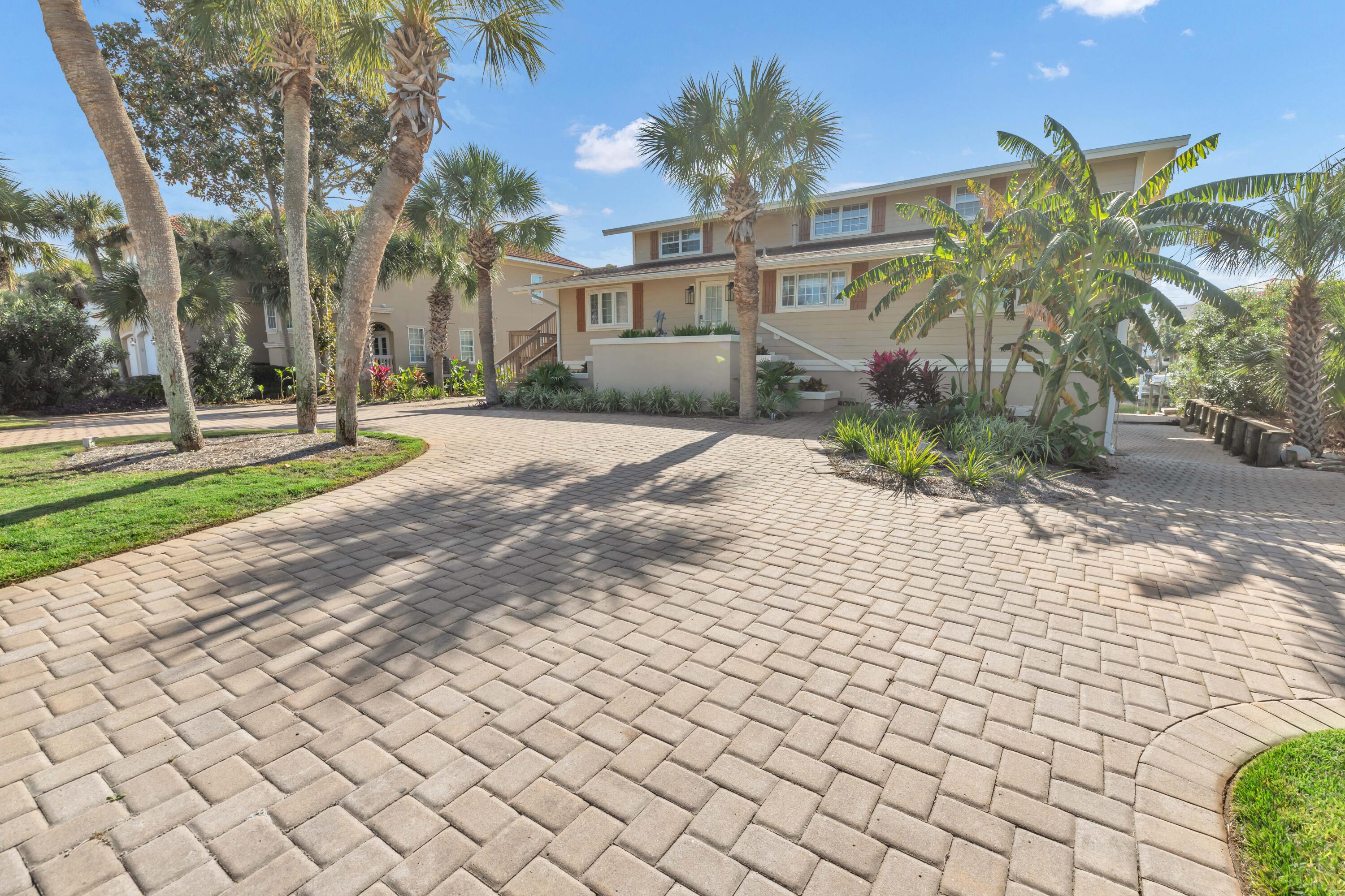 PRICE JUST REDUCED!!  Motivated Seller!  Exceptional Canal Front home offers the perfect blend of coastal living and modern convenience. Situated just one block from the beach with Gulf views and directly on a deep-water canal, this home is truly a rare find.  What sets this property apart is its unique features, including a fully covered and enclosed outdoor entertainment area with observation deck and two covered boat slips with lifts, and an impressive 90 feet of deep-water frontage. The home boasts two separate living areas (2nd Level - Main Level and 3rd Level Lockout) each with their own private entrances totaling six spacious bedrooms, six full bathrooms and two fully equipped kitchens, providing ample room for family & guests.  The large lot can accommodate a pool.