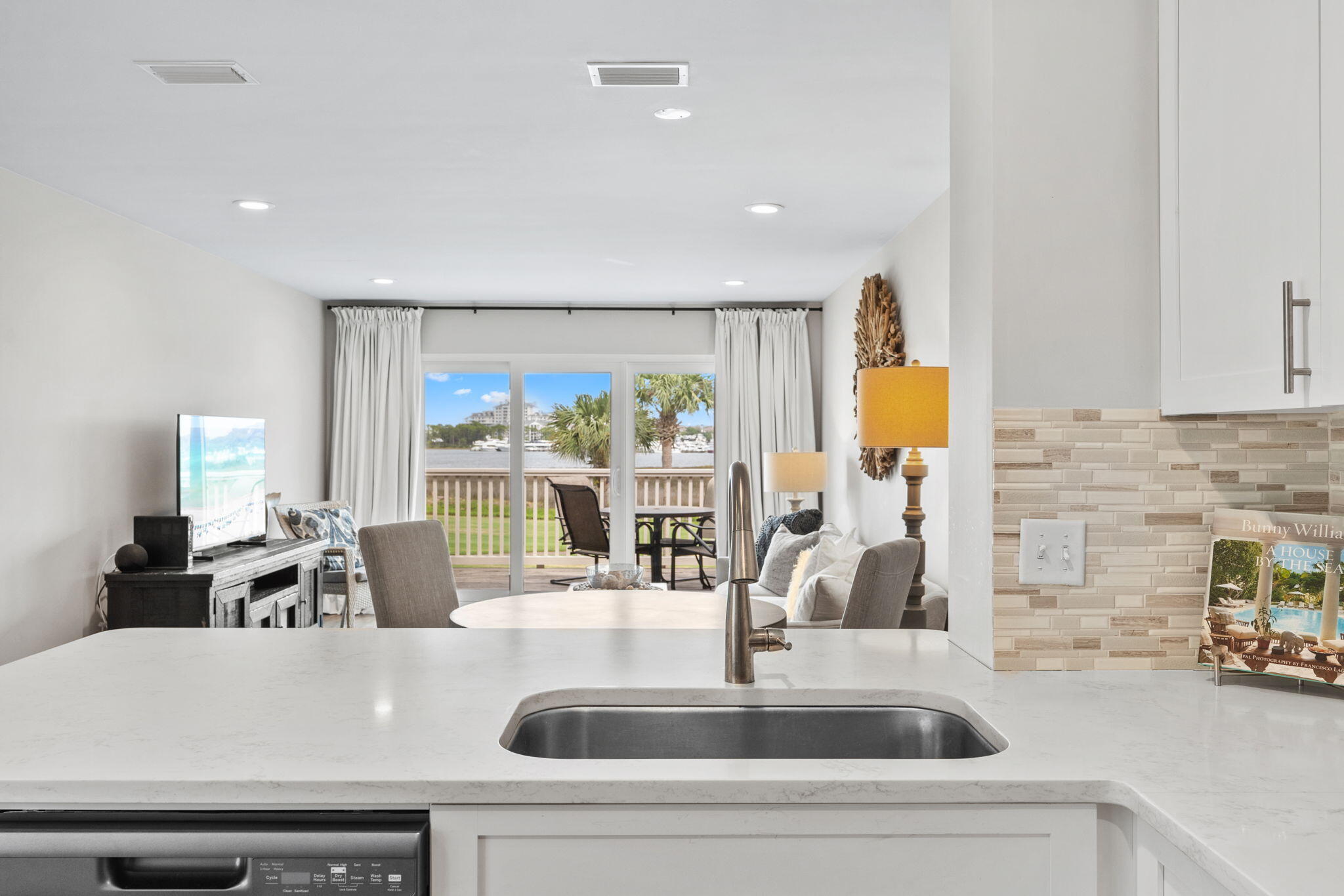New Listing! Turn Key! Short-Term Rental! Golf Cart Included! Welcome to 821 Harbour Point Drive, located in the highly renowned Sandestin Golf and Beach Resort on Florida's Emerald Coast. This beautifully remodeled, top tier, waterfront condominium offers breathtaking panoramic views of Choctawhatchee Bay and Links Golf Course where you can enjoy both sunrises and sunsets from your private balcony. Designed for comfort and style, the open-concept layout features a spacious living area filled with natural light, a fully equipped kitchen, and an inviting bedroom retreat overlooking tranquil lake views—perfect after a day of golf, boating, or relaxing on the beach. Harbour Point is one of Sandestin's most charming golf-cart communities, providing a peaceful escape with a community pool