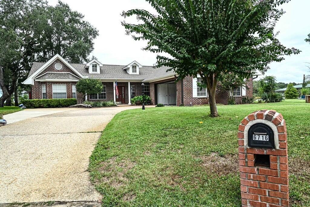 East Bay Waterfront Retreat on a quiet Cul-De-Sac with stunning sunsets over the bay and serene sunrises over the bayou. This charming brick home features 9-foot ceilings and custom 12-inch crown molding. The spacious main living areas and master suite offer elegance and comfort. The master bedroom includes a newly renovated spa bath, and water views grace all north-facing rooms. The gourmet kitchen, complete with cherry cabinets, quartz countertops, a large center island, stainless steel appliances, and a generous pantry, is perfect for culinary enthusiasts. A cozy breakfast nook and climate-controlled sunroom provide peaceful retreats. With 100 feet of East Bay waterfront, a dock, and boat lifts, this home is ideal for water lovers. Unwind outdoors on the deck or in the gazebo! One year home warranty offered from Fidelity National Home Warranty.  New roof and HVAC in 2018. Pipes in home replaced, spa bathroom and new water heater all in 2024