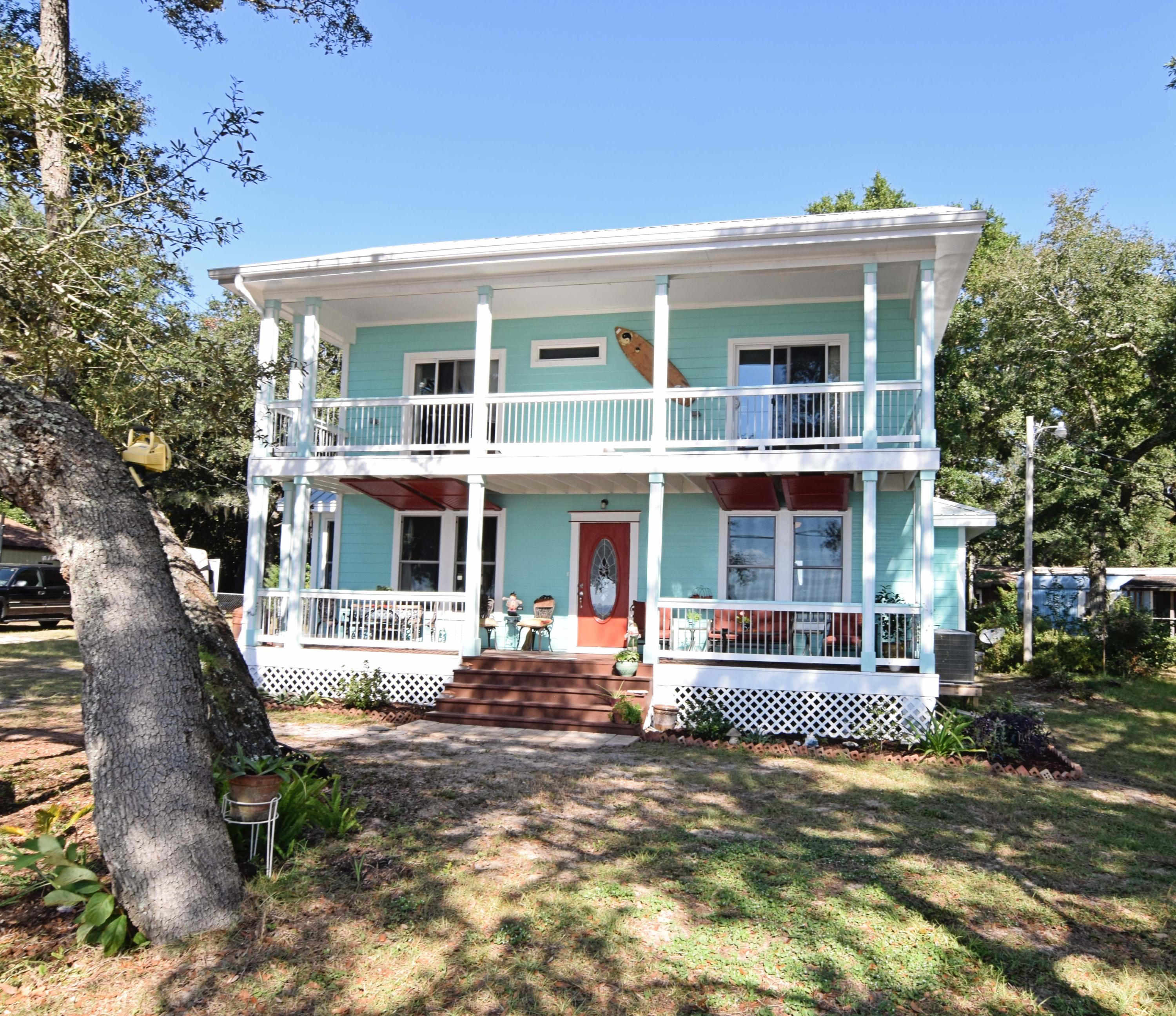 This lovely home offers magnificent water views from every room! Imagine going through your day watching the surface of the Bay changing from still and smooth as glass to gentle waves. The dolphins play and the clouds reflect like artwork just outside of your home!
The charm of this home starts the moment you drive up- from the beachy exterior colors to the wide porch and balcony, to the surfboard mailbox, the entire home beckons you inside.
As you enter the home, you are greeted with a large open space full of windows. The family room is large with a cozy alcove, perfect for a reading nook or a grand piano. The dining area shares the space and is open to the kitchen, where the breakfast bar is a good place to finish homework or keep the family cook company as they work. The laundry roo is off of the kitchen and a large powder room nearby. The master suite is on the first floor, with a wonderful water view that might make it hard to get going in the morning. The master bath has a separate tub and shower with a large walk-in closet. Two additional bedrooms are upstairs and share both a full bath, and access to the huge balcony, the perfect spot to watch a sunset and see the lights of Destin across the bay. Come and see this beautiful home today- sit on the gorgeous porch for awhile taking in the views, and I promise you will not want to leave!
