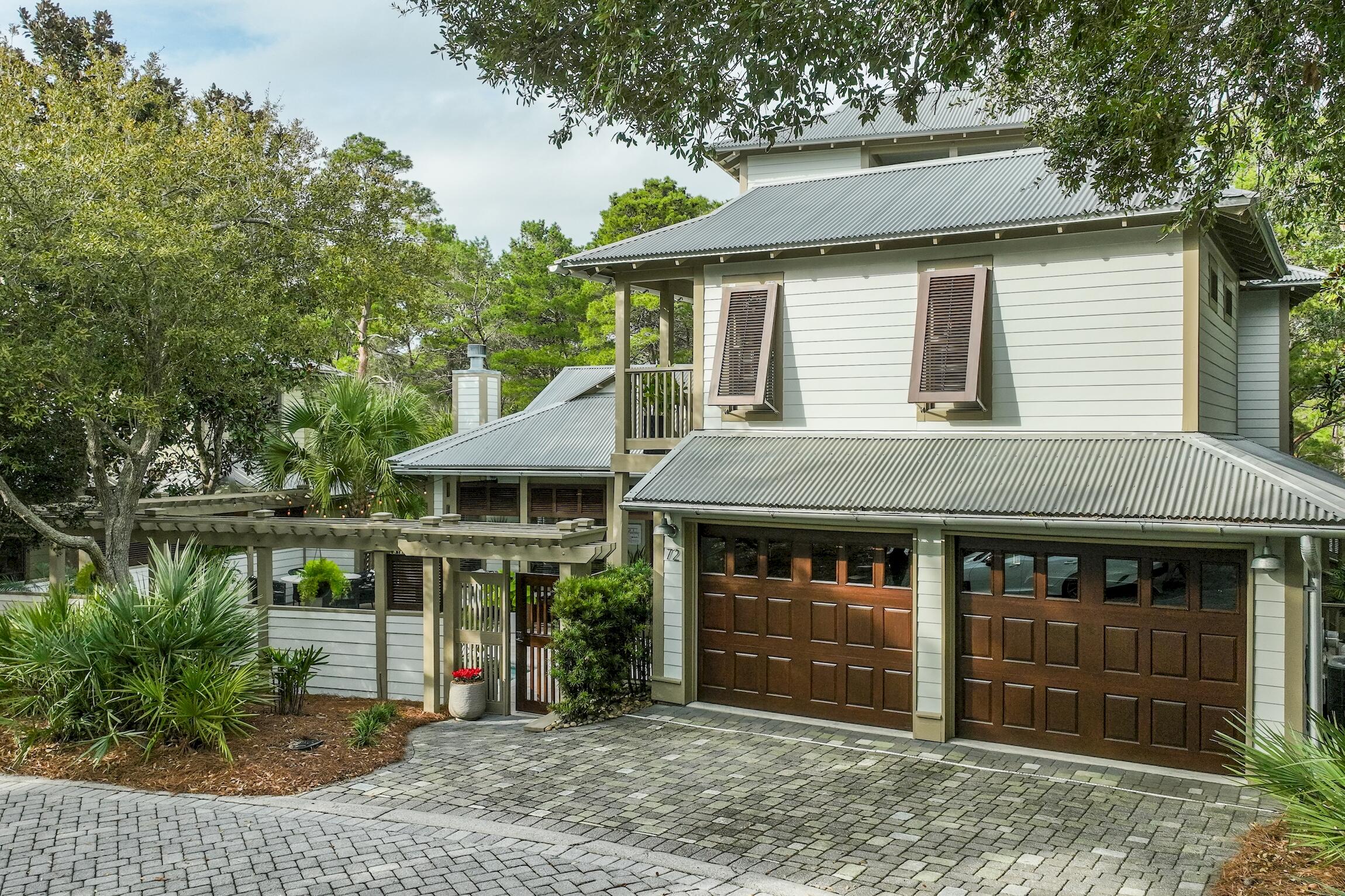 What an incredible opportunity to own a BEAUTIFUL HIDDEN GEM! These homes do not come available very often and this one has it all. This beautifully renovated 4 bedroom home is located in the gated community of Summer Ridge. Its comes complete with a carriage house, 2-car garage,  and a heated pool. Upon entering the private courtyard you will be greeted with a serene ambiance of the pool, new shell stone patio, Fire table, and privacy. Enter through through the double coffee stained wood and glass doors and you will find a vaulted wood beamed ceiling, gorgeous windows, and wood floors. The Great Room is open to the kitchen and dining areas for maximum spaciousness. The kitchen is delightful with a gas stove, french door refrigerator, microwave and a built in ice maker. Make your way down the hall where you'll find a laundry room, powder room, and First floor Primary bedroom with double walk in custom closets. The Primary bath has been remodeled as well. There's a separate water closet, walk in shower, double vanity with plenty of storage and an original cast iron soaking tub. This is the ultimate if you've ever had the privilege to experience one of these. Ascend the staircase and you'll find two spacious bedrooms that share a hall bath. Both bedrooms have access to the covered porch where you can see the pool and court yard. Ascend the stairs once again and you will be greeted to a bonus room complete with a wet bar and private covered porch. This room is currently used for entertainment, however it could be an office, workout room, or artist's studio. Once back in the courtyard, the stairs take you to the carriage house where there is a delightfully private guest quarters completed with full bathroom and guest closet. Summer Ridge is very special and this home exudes tranquility and yet you are near 3 Beach Accesses, wonderful restaurants, and shopping. This is the ultimate in 30A Living. Short term rentals are restricted in this community.