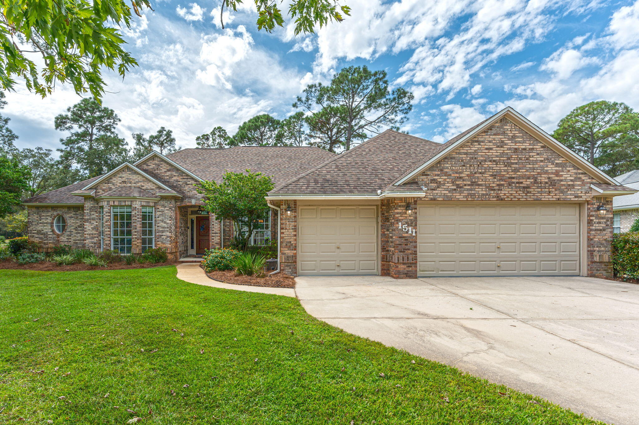Practically Perfect on Pinehurst Cove! This Bluewater Bay beauty checks ALL the boxes! Pool? Yep. 3-car garage? Yep. 5 bedrooms? Yep. 4 bathrooms? Yep. Updated kitchens and bathrooms? Yep.  Fenced yard? Yep. Screened In Pool & Spa? Yep. No HOA? Yes! And it's on over a half acre lot (.54)!!!  Welcome home to this fabulous single story property located near the Bluewater Bay tennis, pickle ball, golf and pools and zoned for the top ranked Niceville schools! This rare gem boasts front yard and back yard appeal with mature landscaping, lush grass, fenced yard, screened lanai with pool/spa, and overlooks the current golf course! From the moment you open the front door you can appreciate the breath of space this floor plan offers.  The foyer is open to the formal living and dining room....=> and all of the flooring in the main living areas is consistent which draws your eye throughout the home. The formal living room has an impressive wall of windows overlooking the resort like back yard and drives home the appeal of indoor outdoor Florida living.  The kitchen has been recently renovated and is equally beautiful and functional.  The cabinetry draws the eye up and shows off the high ceilings with cabinets that go all the way up!  The glass illuminated display cabinets will showcase your personal treasures allowing them to add to the decor.  Every cook will appreciate the gas stovetop with a stunning hood vent moment. The quartz countertops and marble backsplash showcase the exquisite design choices made during the selection process and the built in pantry, oversized chef's sink and contrasting island are all details that will make you want to spend plenty of time in this heart of the home.  The eat in kitchen area accomodates a full size 6 person table and overlooks the backyard which will beckon you to go outside but not before walking through the charming family room.  The vaulted ceiling in the family room with center beam is a show stopper and the wood burning fireplace is so inviting.  The french door leads you from the indoor oasis straight to an outdoor oasis, but we still have too much to talk about before we go out there!  This home has 5 bedrooms, that's right, 5!!!  Many of the bedrooms have walk-in closets.  The primary suite is a relaxing retreat that has a nicely appointed ensuite.  There is even access out to the pool and spa from that room.  The other guest rooms are in pairs on split sides of the home, each with Jack & Jill baths.  Storage is also abundant with large closets, additional linen closets, a second pantry and incredible built in storage in the laundry room.  Plus...a 3 car garage with space for any overflow!  All of this and a showstopper pool oasis overlooking the lush green of the golf course with so much space on this very large lot.  The back area affords views and privacy and really invites you to enjoy the outdoors.  Whether you are ready to take a dip in the pool or bbq with friends or just enjoy the quiet, you will want to make this home your own.  Make an appointment to see it today!!!