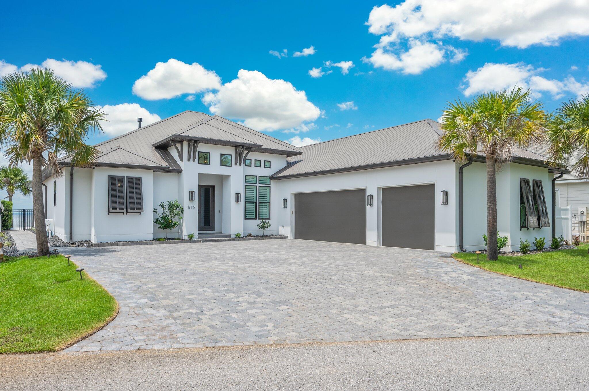 BAYFRONT LUXURY LIVING - PRIVATE DOCK, POOL, AND PANORAMIC VIEWS! Experience the ultimate in upscale coastal living with this custom-built Bayfront masterpiece, thoughtfully designed to capture sweeping water views from nearly every room. This stunning home offers a seamless blend of refined indoor comfort and exceptional outdoor living. The gourmet kitchen is a showstopper, featuring a large island, and quality SS appliances. Outside, paradise awaits. Enjoy a private boat dock with lift, jet ski lift, and swim platform - ideal for fishing, dolphin watching, or sunset cruises from your backyard. The covered patio, outdoor fireplace & summer kitchen overlooks a sparkling private pool & tranquil water fountain! Oversized 3-car garage, and amazing location!  Waterfront living at it's finest! This prinstine property comes with a tremendous amount of additional upgrades, such as: 
a 27kw Generac whole house generator installed in 2024, New AC's installed in April '2024 as well as a tankless hot water heater and an outdoor rust removal water system for irrigation. This property includes everything a meticulous buyer could ask for.