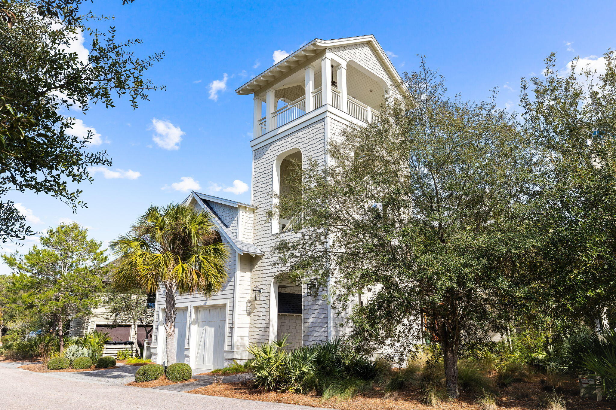 Nestled within WaterSound Beach, this refined home captures the essence of beach living while delivering gulf and coastal dune lake views. The creative design of architect Dawn Thurber captivates, from the entry boardwalk passing under the home's four-story tower to the front and rear porches that take advantage of the home's private position on a tree lined Watersound community park. The home's exterior provides a warm welcome through a private courtyard with bubbling water feature, landscaping native to the Florida panhandle and cascading crescent steps leading to the home's front door. Featured in ''Coastal Lifestyle'' magazine, the home's vaulted ceilings, white oak floors and nautical tongue-in-groove wall boards balance Nantucket coastal charm with casual elegance. On the first level, the primary suite boasts a walk-in wardrobe and ensuite with a custom-tiled shower, dual vanities and a soaking tub.Two additional bedroom suites, a laundry center and a sleeping porch complete the first level. Take the elevator or stairs to the second level filled with natural light, large windows and vaulted ceilings. Creating a great space for cooking and entertaining, the gourmet kitchen features custom cabinetry and tile work by Emerald Coast Fabrication and ample seating around the expansive island.   The living and dining areas, featuring a tabby fireplace, flow seamlessly onto the large covered porch for al fresco dining and conversation space. An additional bedroom suite, wet bar, powder room, built-in desk, and access to the unrivaled open-air living and grilling deck are also found on the second floor. Outdoor enjoyment abounds with a grilling porch featuring an outdoor fireplace and television, and a fourth-floor tower with stunning gulf views, providing a combined 2,400 square feet of space to enjoy the home's prime position. An oversized two-car garage, irrigation system, landscape lighting, built-in safe, central vacuum system and home automation, elevate this home to meet the needs of discerning beach enthusiasts seeking an extraordinary home that provides exceptional living. 

WaterSound Beach provides world-class amenities in a private gated setting, offering direct beach access, miles of nature-filled boardwalks and pedestrian bridges, community swimming pools, community fitness center and a poolside cafe.
