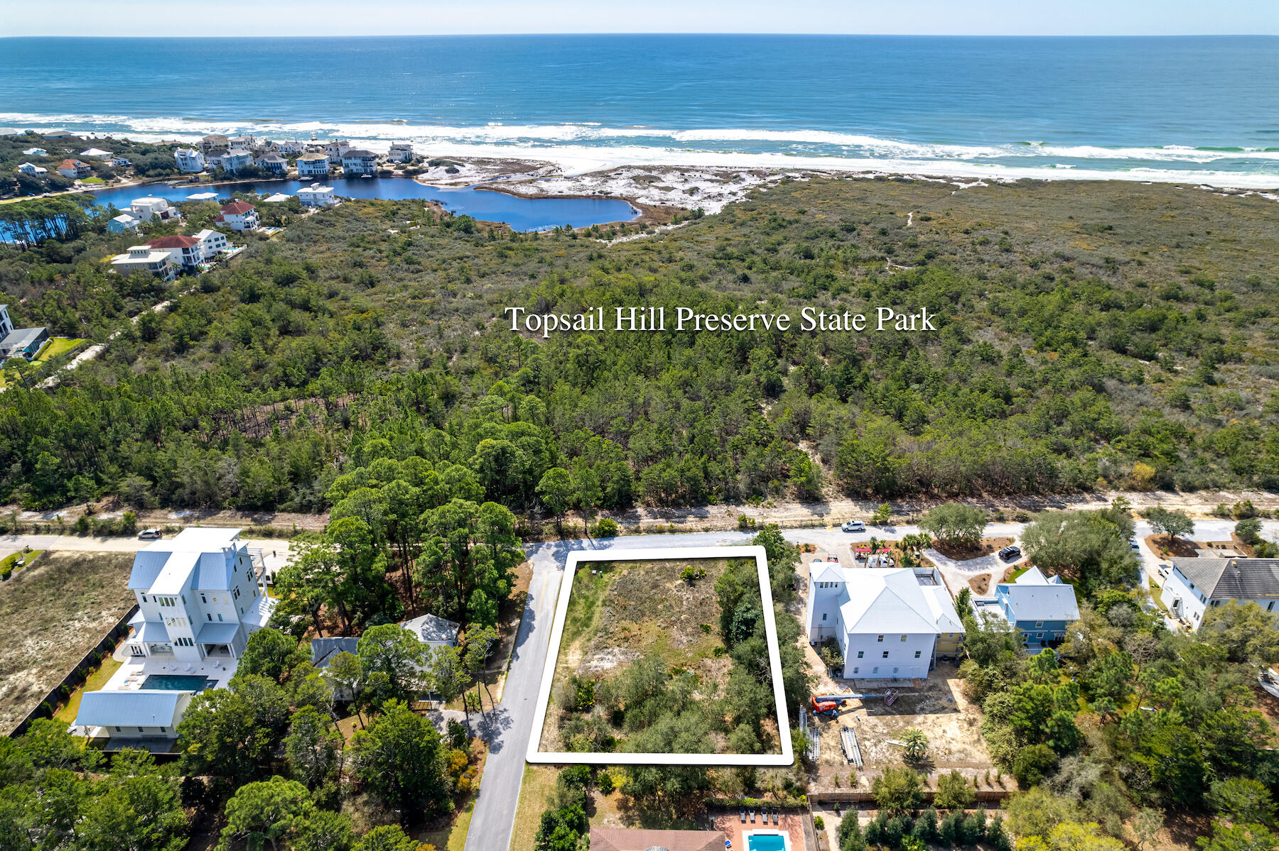 SPACIOUS LOT WITH GULF VIEWS!  Located alongside Topsail Hill Preserve State Park on 30A's peaceful west end, this south facing homesite offers amazing sunset landscapes with VIEWS OF THE GULF OF MEXICO and a rare Coastal Dune Lake. This spacious 100' x 140' lot with additional buffer space is located within a quiet community with NO HOA. Access to Topsail Hill Preserve State Park is located nearby along with locally owned restaurants, Butler Elementary School, Sacred Heart Hospital and the town centers of Gulf Place and Grand Boulevard with shopping and dining.