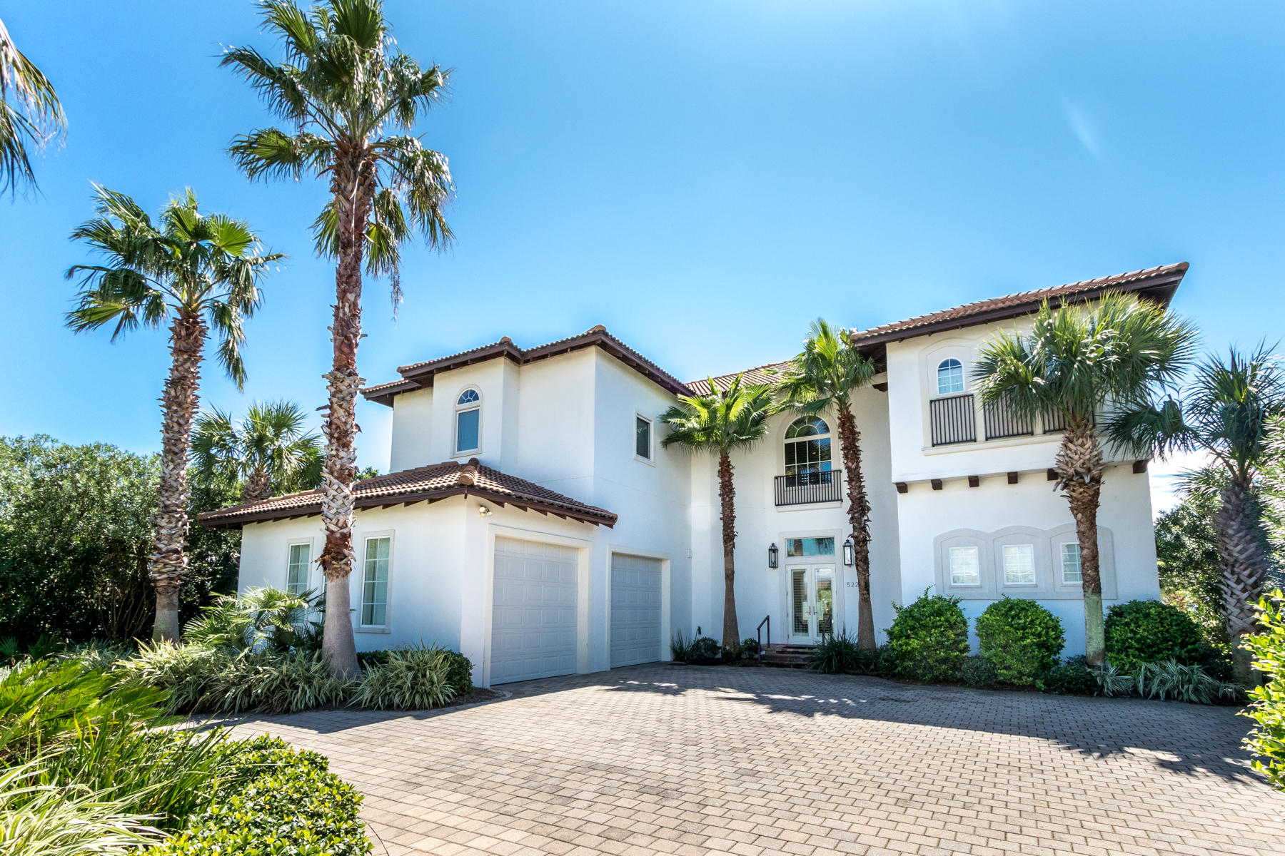 This Holiday Isle charmer embraces 90' of shimmering waterfront. You need not do a thing to improve this immaculate, well-designed home - except show up with a boat or three. The boat slips are 16' X 30' and 20' X 40' with a pull-beside dock. Just one street back from private beach access, vacation renters return year-after-year. 2019 rental income topped $100,000.  Whether poolside at your full-sized water front heated pool/hot-tub or dockside, just minutes from Crab Island revelry, harbor front dining, or deep-sea fishing, life at 522 Vera Cruz is all about sun and sea. A bright white exterior leads to neutral décor, industrial modern touches, and timeless design. Added touches of alluring coastal color, a reliable blend of hardwood and stone flooring, an enviable designer kitchen, private multiple living spaces, and sultry fireplace and achieve a space that is ageless.  Four of six generous bedrooms include sparkling water views and enjoy five and two one-half well-appointed bathrooms. Deep balconies are perfectly positioned to take in sparkling water views. Located between the Harbor and Gulf of Mexico, the 3-mile peninsula of Holiday Isle is characterized by its pristine beaches, friendly sidewalks, and ever-changing Harbor views. Call to experience your private showing of this stunning home.