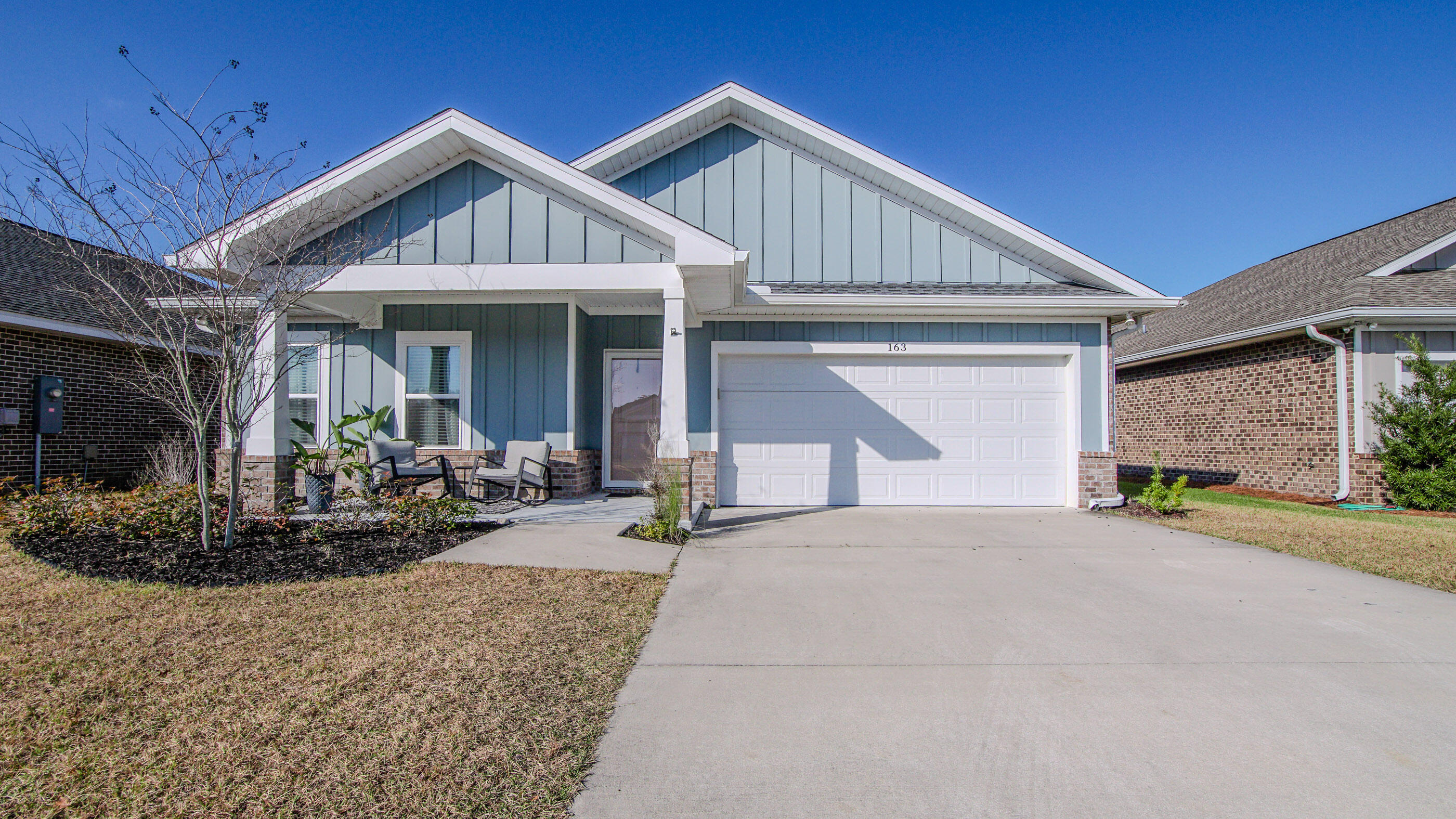 Welcome home! This 2022 built home is TURNKEY-pride of ownership abounds and is evident upon entering the property. The front of the home is nicely landscaped and features a covered front porch and a board and batten exterior with brick skirt- coastal craftsman charm. The interior features raised ceilings, providing a spacious feel throughout both the bedrooms and main living spaces. The split bedroom floor plan positions the two additional bedrooms and guest bathroom in the front of the home, with the main living space housing soaring trey ceiling. Tons of natural light keep the interior light and airy, with LVP flooring throughout the main space and only carpet in the bedrooms. This kitchen is a chefs dream with ample counter and cabinet space and large kitchen island overlooking the living room. Matching granite countertops throughout the kitchen and bathrooms. Master bedroom features en suite with master bath housing double vanities, soaking tub with tile surround, walk-shower, and custom master closet. Notable interior features include blinds and draperies, kitchen backsplash, and garage workbench. The exterior is built for Florida living with covered back porch and additional covered patio allowing for entertaining, seating, and grilling. Climate controlled shed offers ample storage space. Backyard is fully fenced and home has full gutters surrounding, as well as irrigation system. Home also features a Culligan whole house water softener. This home is truly move-in ready-schedule your showing today!