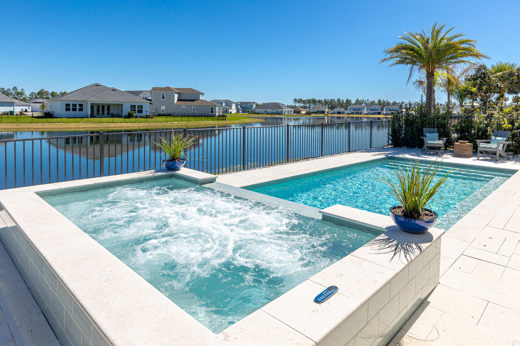 Perfectly situated on a premium lakeside lot inside the gates at Naturewalk  Watersound Origins. Stunning 'Tampa' plan is the largest (4001 total sq ft - 2801 total living) Single level built in NW community. This pristine home has an abuidance of upgrades including beautiful hardwood flooring, shiplap accent walls,10 foot celings, georgeous designer lighting, electric fireplace. Custom Shutters and window treatments. 4thBR being enjoyed as an offfice with sliding glass doors. Gourmet Kitchen w/ gas stovetop,wine refrig., soaring cabinetry with lit glass display shelving, oversized island with bar seating and pantry. Bring the outdoors in by sliding the 5 panel glass doors open to the spacious enclosed Lanai with automatic privacy screens that open to a huge spa and saltwater heated pool! Patio is complete with furnishings from "Tuskers". Enjoy a game on the TV as you grill up dinner, or just relax in front of the firepit. 
The Primary Suite is a sancuary with an oversized ensuite complete with walk-in shower and deep soaking tub, large walk-in closet w/island cabinetry and private access steps from the pool and spa. Two additional Guest Rooms one has private ensuite and walk-in closet. All rooms come with Televisions, furniture is negotiable. Bright open Laundry room includes GE washer & dryer with large walk-in storage room and alarm system control panel.  Parking is a pleasure in this 3 car garage, that includes attic storage with pull down ladder.  Also included is a 4 seater golf-cart and four touring bikes to explore this beautiful area, Alys/Rosemary Beach is just a short bike ride down the art bike path, indulge in the numerous shops, galleries and restaurants you will discover. NW amenities include Golf, Pickleball, Tennis, nature paths, fitness center,Pool pavillion and  Events pavilion, with a farmers market, Enjoy the newly opened Publix as well as numerous shops, bakery, and restaurants opening along the Boulevard. NW is convinently located 30 minutes to the PCB airport, and 30 Minutes to Destin. As a Naturewalk owner you also can purchase a Beach Club membership.