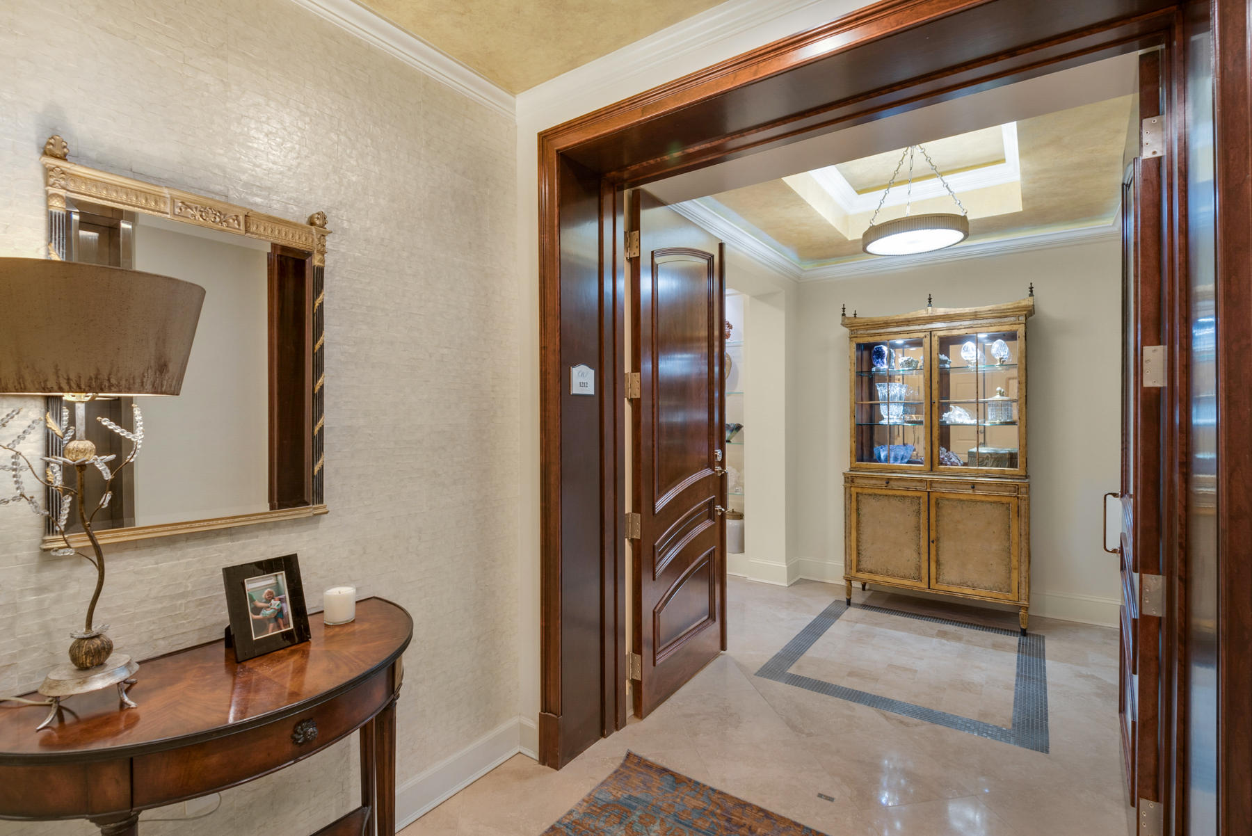 This highly sought-after Darlington floor plan on a high floor in building 3 rarely comes available. This unit was totally renovated when the current owners purchased and no expense was spared. This condo is a must see as there are too many upgrades to describe. The elevator takes you directly to your private elevator foyer. Enter the unit through beautiful mahogany double doors. Upon entering the condo there are 2 guest bedrooms with private baths and a laundry room. As you walk down a gorgeous wide hallway there is a study/family room and a living room divided by a two-sided gas fireplace. There are 2 spacious terraces as well as a walkout balcony off the master bedroom. One terrace can be accessed from one of the guest bedrooms as well as the family room. The other is accessed from the living room and includes a full summer kitchen with built-in gas grill, a double gas burner cooktop and 2 refrigerator drawers.  Across from the living room is the kitchen, dining room and wine room.  The kitchen is breath-takingly gorgeous with hard to find and very high-end Blue Louise Quartzite.  The kitchen was renovated to include loads of cabinets.  You will not run out of counter or cabinet space in this condo.  The plugs are hidden and pop up as needed.  High end appliances and a floating island are also included.  The wine room has a pocket door and more Blue Louise countertops and loads of wine storage space.  A separate alcove past the kitchen could be used as an office area or a breakfast room.  Continue down a private hallway to the spacious master suite with incredible views.  The master has a balcony from which you can enjoy forever views of the Choctahatchee Bay.  The master bathroom is enormous and includes a tub, separate his and her vanities, a walk-in shower and a large walk-in closet. All bathroom countertops are marble.  There are unique chandeliers and light fixtures throughout the condo.  Also included, 2 separate HVAC units, 2 parking spaces, a golf cart space and 2 storage lockers in the garage and 2 additional storage closets.  One Water Place has fabulous amenities. including outdoor pools, indoor and outdoor spas, a full fitness center, locker rooms, game room, theater room, gorgeous lobby, gardening facility, boardroom and party room, dog park, walking trails and much more!  In addition, the gated and guarded Kelly Plantation Subdivision offers a world class Fred Couples Golf Course, clubhouse, owner's club, and stables.  Condo is sold unfurnished but furnishings are negotiable.