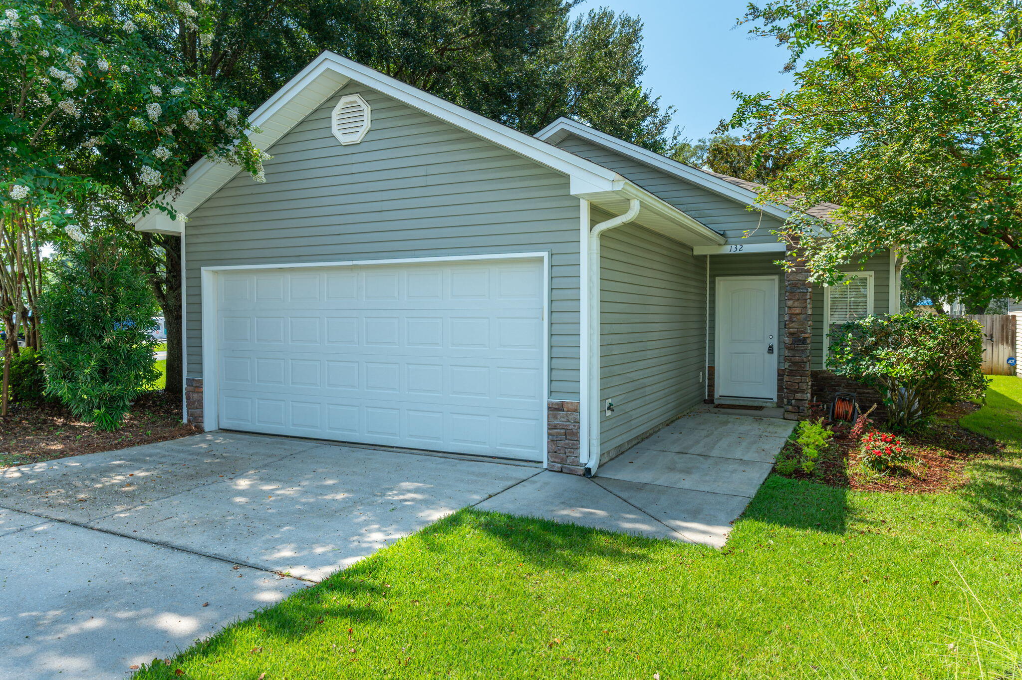 Welcome to this beautifully landscaped 3-bedroom, 2-bath single-family home in the heart of Niceville. With its inviting curb appeal, vinyl siding with stacked stone accents and low-maintenance design, this home offers comfort, style, and practicality.

Step inside to a warm and welcoming living room featuring hardwood floors, recessed lighting, a ceiling fan, and plush carpeting that continues into the bedrooms. The kitchen is both functional and inviting, showcasing stone countertops, a tiled backsplash, upgraded maple cabinetry, stainless steel appliances, and a cozy eat-in area perfect for casual meals or a small dining setup.

The primary suite includes soft carpeting, a ceiling fan, and an extra-long vanity with cabinetry that matches the kitchen for a cohesive design. The attached bath features a glass-enclosed walk-in shower. The two additional bedrooms are also carpeted and share a full bathroom with a matching vanity and a shower-tub combo.

Additional highlights include washer and dryer hookups, a privacy fence enclosing a zero-maintenance backyard, and a small patioideal for a grill or outdoor dining setup. This property offers comfort, convenience, and classic Niceville charm. Contact us today for your private showing!