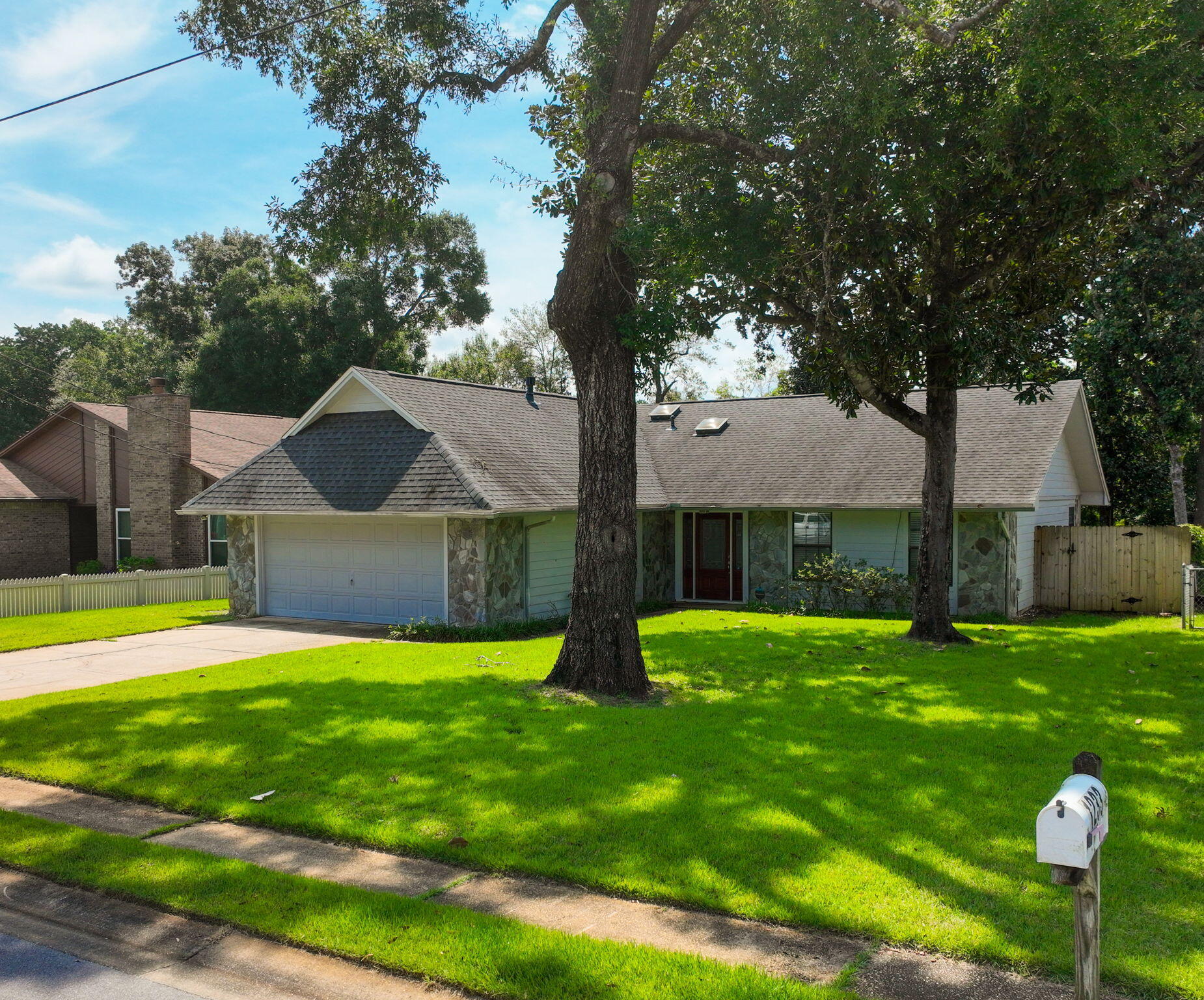 Beautifully updated home in the heart of Niceville! This property features an open and inviting layout with a spacious living area, vaulted ceilings, and a cozy stone fireplace. The kitchen shines with granite counters, stainless appliances, and plenty of cabinet space. Both bathrooms are modern and stylish, and all bedrooms are generously sized. Enjoy wood-look tile in the main living spaces, fresh carpet in bedrooms, and a large fenced backyard that gently slopes to Swift Creek — a serene outdoor retreat. Conveniently located in close proximity to bases, schools, shopping, and just a short drive to the beaches of the Emerald Coast. Move-in ready and waiting for you!