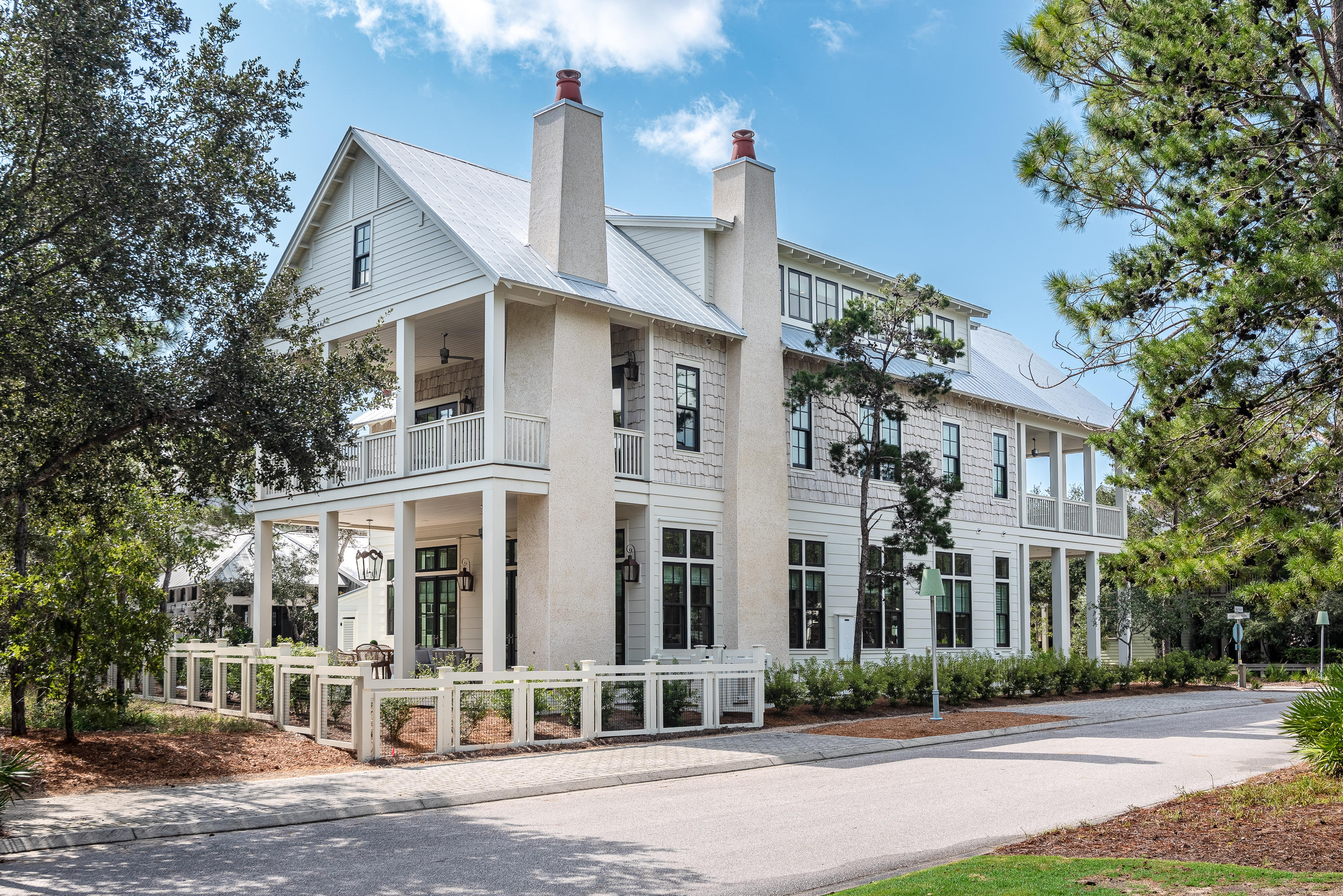 Light and space define this immaculate, newly-constructed luxury beach home.  Situated on an oversized corner lot, with preserve land to the rear and a pedestrian greenway across the street, the house at 42 Flatwood presides over one of the community's most enviable locations. 12' ceilings on the first floor and a warm shade of white paint, along with an extensive number of transom windows, lend an ethereal feel to an already superbly decorated living area.  

Boasting six bedrooms, each with their own en suite bathroom, across 5,552 square feet of conditioned space, very few homes in the community are larger than this one.  None are as beautiful.  

Attention to detail in construction extends to tile and other selections. From the penny round flooring and dazzling mosaic shower walls, with Grohe faucets, Mirabelle sinks and white Carrara marble countertops, elegant hardwood flooring and with v-groove wood walls in the main living spaces, 42 Flatwood is a house that is unparalleled in fit-and-finish.  Abundant amenities of the property include surround sound throughout the house, a large pool with a cabana restroom, 1,620 square feet of porch space, two outdoor and one indoor fireplaces, a large outdoor lockout storage closet, Wolf and Subzero appliances, a beverage refrigerator, an ice machine, and a luggage lift that can be converted into an elevator.  The length of this home overlooks High Street -the path of which is the most direct and easy route to the Sand Hill community pool and to the beach from the Lake District.