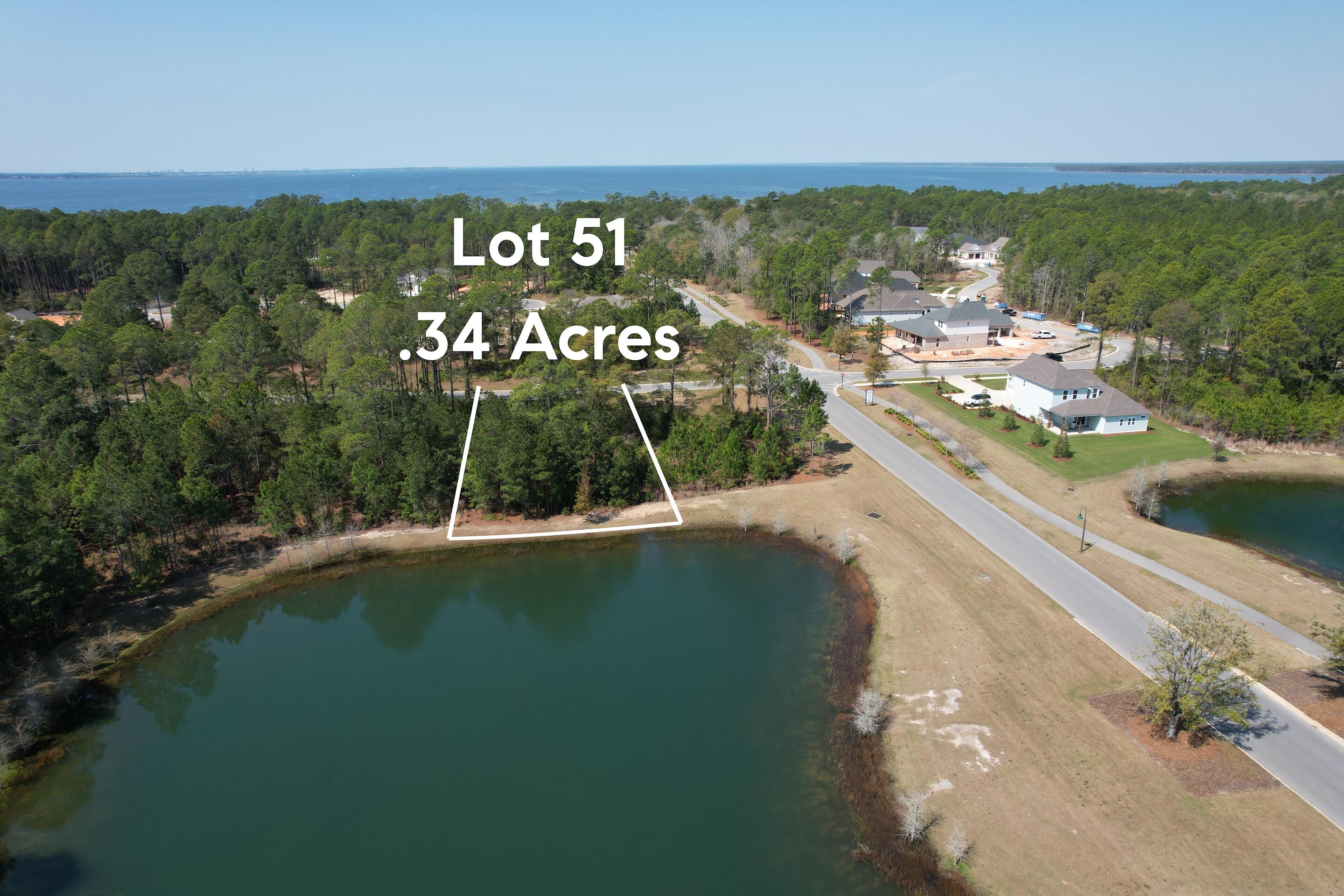 Build your custom dream home on this 0.34-acre waterfront lot in Hammock Bay located in the gated Steamboat Landing community in Freeport. This wooded homesite with pond view offers privacy and scenic surroundings, backing directly to a tranquil pond with full water views.

Ideally situated near the front of the neighborhood, this lot is within walking distance to the Bay Clubhouse and bayfront dock. Utilities are already in place, making it ready for your new construction home. Unlike many other sections of Hammock Bay, this lot allows you to choose your own builder, giving you flexibility to design a fully custom home.

Steamboat Landing is a gated community with access to all Hammock Bay amenities, including resort-style pools, fitness centers, walking and biking trails, pickleball courts, basketball courts, playgrounds, kayak launch, and multiple clubhouses. Convenient access to local favorites like Props Brewery, Abide Coffee, neighborhood shops, and Freeport Middle School.

Located just a short drive to the white-sand beaches of the Emerald Coast and 30A, this is a rare opportunity to own one of the last available lots in Steamboat Landing. Perfect for building a primary residence, second home, or investment property in one of Freeport's fastest-growing communities.

Buyer to verify all information.