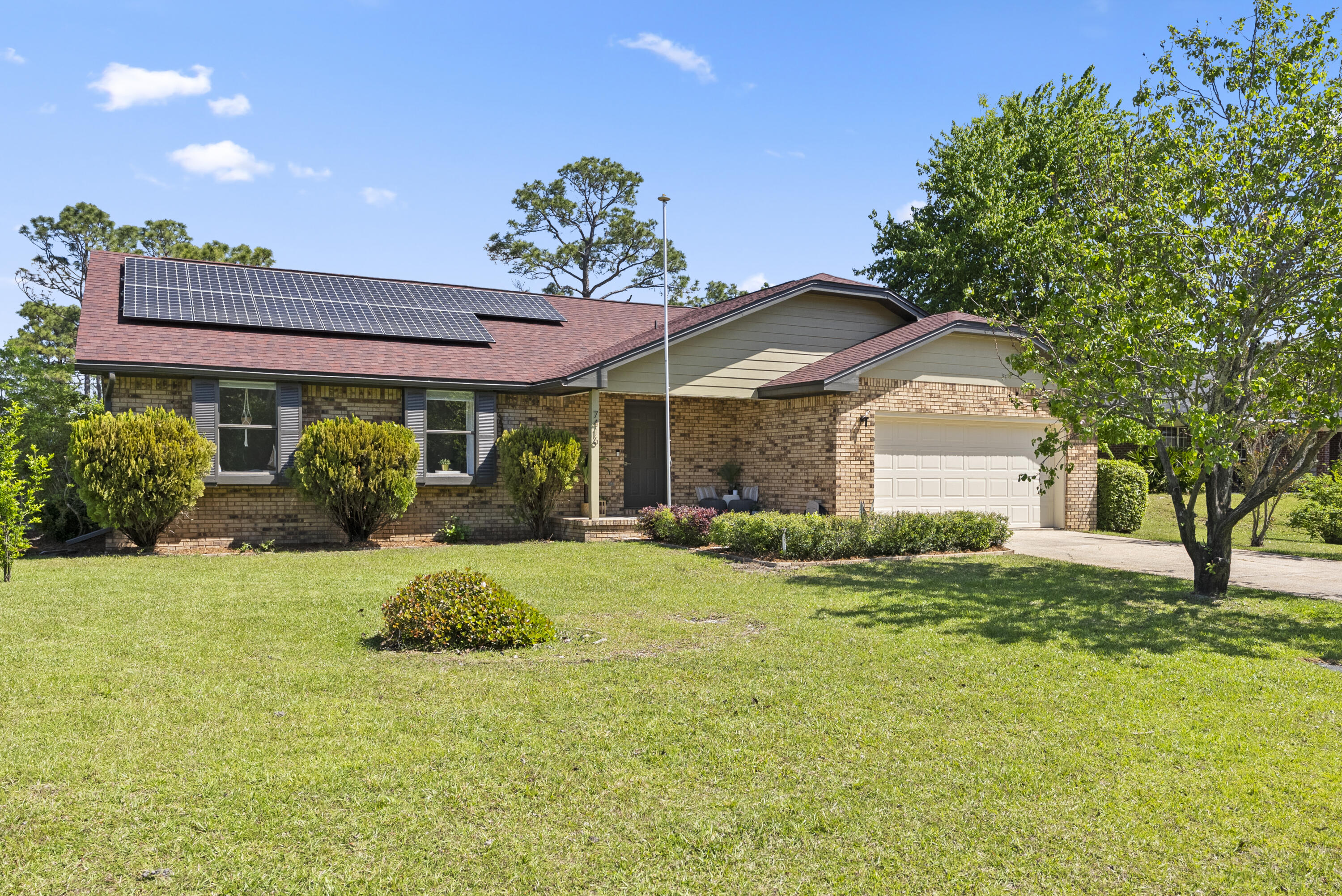 Charming Brick Home on Spacious .73-Acre Lot. 
Nestled in the highly sought-after Holley by the Sea, this beautifully renovated 3-bedroom, 2-bathroom brick home offers 1,448 sq. ft. of comfortable living space on an expansive .73-acre lot. Thoughtfully updated by its current owners, this home blends modern updates with timeless charm. Notable upgrades include a new roof (installed May 2021) and fully paid-off solar panels (installed July 2022), ensuring energy efficiency and reduced utility costs.

Inside, an inviting open-concept layout is accentuated by a vaulted ceiling in the living room, enhancing the sense of space and light. Stylish LVP flooring flows throughout, adding elegance and durability. The split-bedroom floor plan ensures privacy for all. The heart of the home is the spacious kitchen designed for both gatherings and everyday living, featuring a large breakfast bar with ample seatingperfect for casual meals and entertaining.  The primary suite offers a private retreat with a walk-in shower in the en-suite bathroom.
Step outside to a screened-in patio, perfect for year-round enjoyment. The fenced backyard with a double gate provides privacy and plenty of space to expand, garden, or simply relax. An irrigation system that keeps the lawn lush without added water costs.
This home has been used as a second residence, and the gently used furnishings are negotiable. Conveniently located near beaches, shopping, restaurants, and military bases it offers both tranquility and accessibility.
As a resident of Holley by the Sea, you'll enjoy exclusive access to the 45-acre private recreational center, featuring:
 8 clay tennis courts
 3 swimming pools
 Full gym & aerobics studio
 Lighted basketball courts
 Sauna & steam room
 Playground & game room
 Community clubhouse on Santa Rosa Sound
 Dock & East Bay boat launch
 Year-round community events

Don't miss this rare opportunity to own a beautifully updated home with incredible amenities and a prime location!